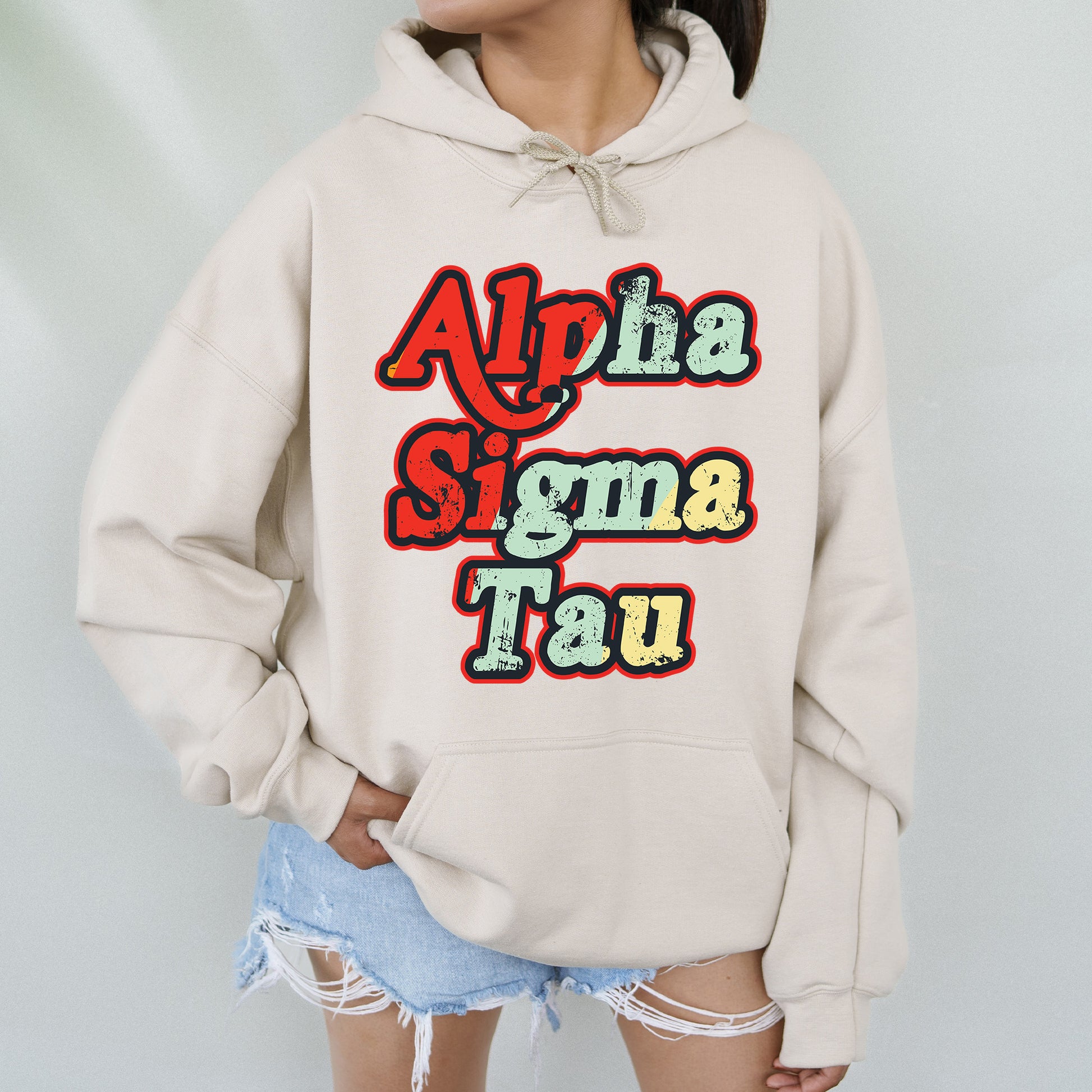 a woman wearing a white sweatshirt with the words aloha stigma tau on it
