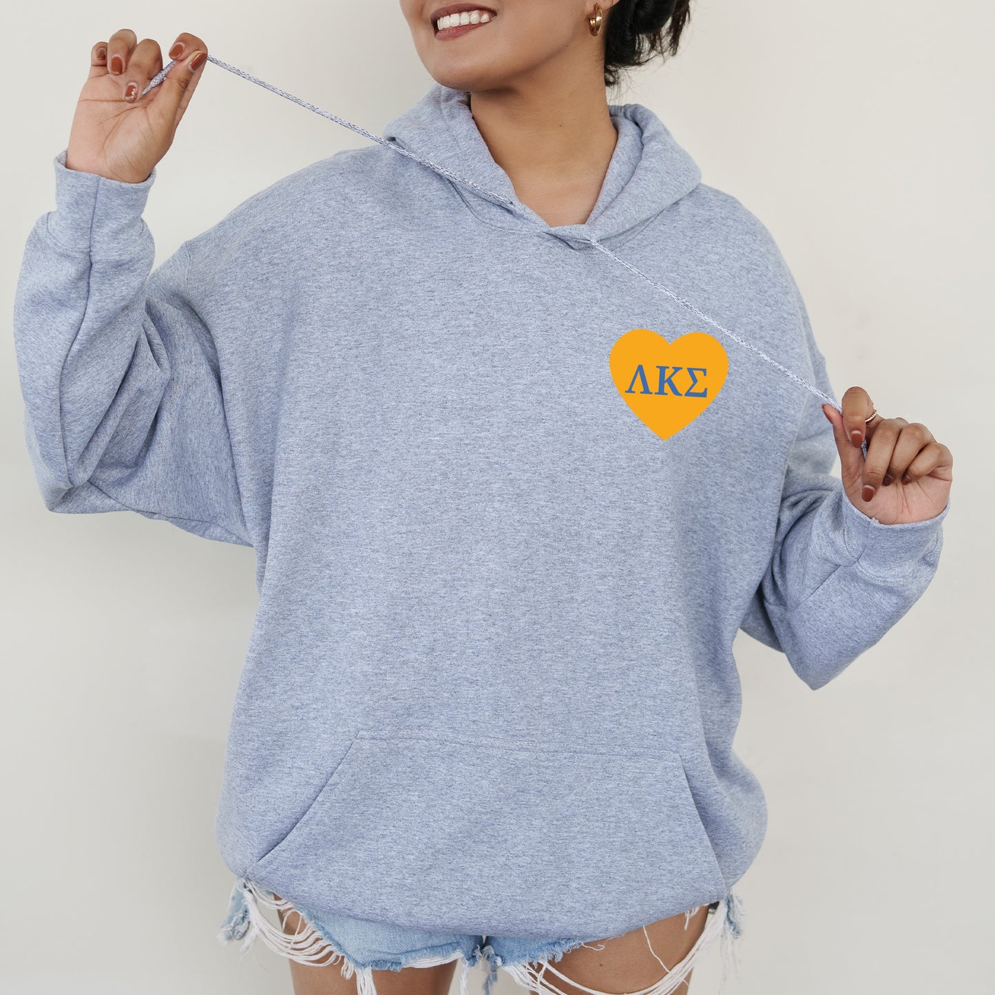a woman wearing a blue hoodie with a heart on it