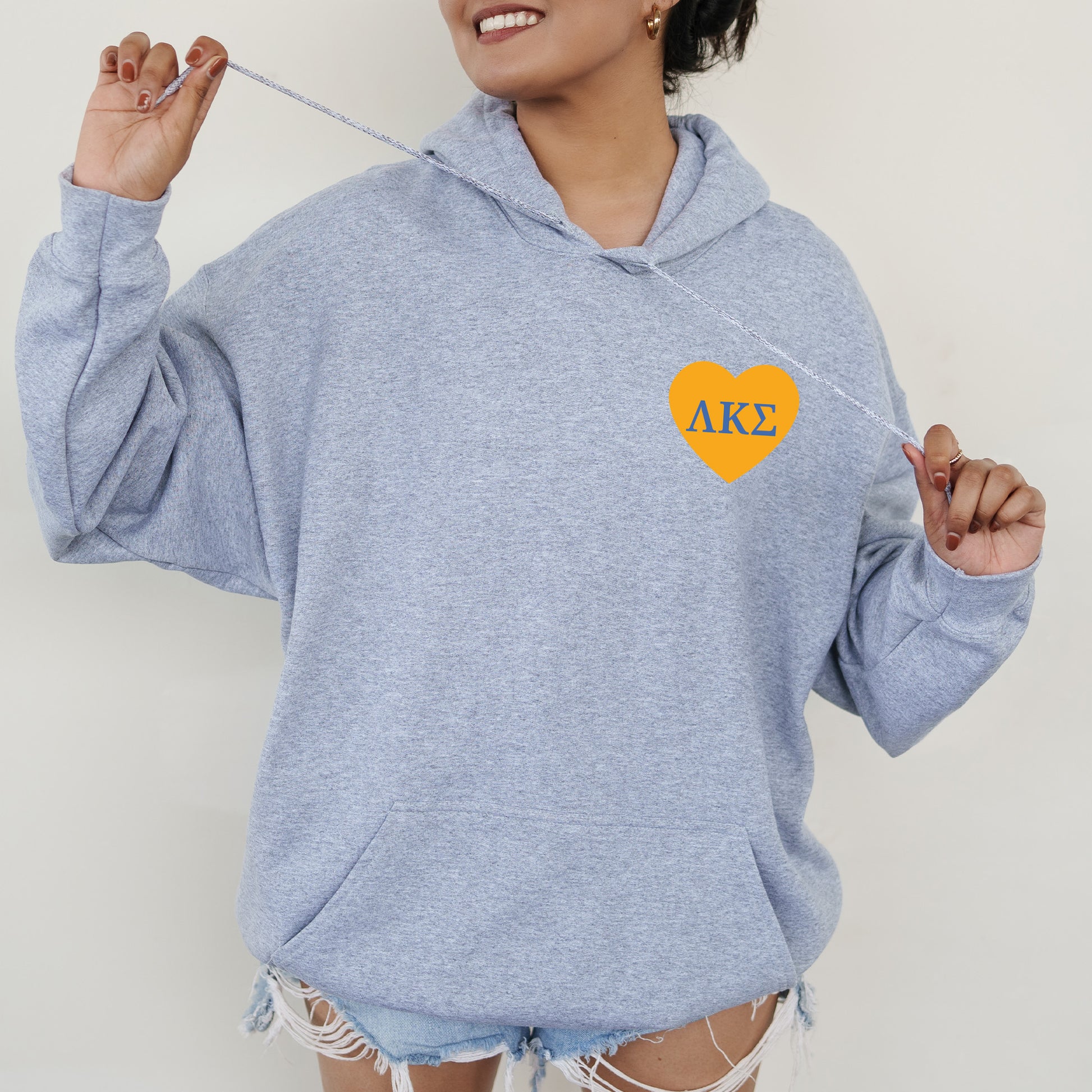 a woman wearing a blue hoodie with a heart on it