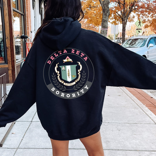 a woman in a black hoodie is walking down the street