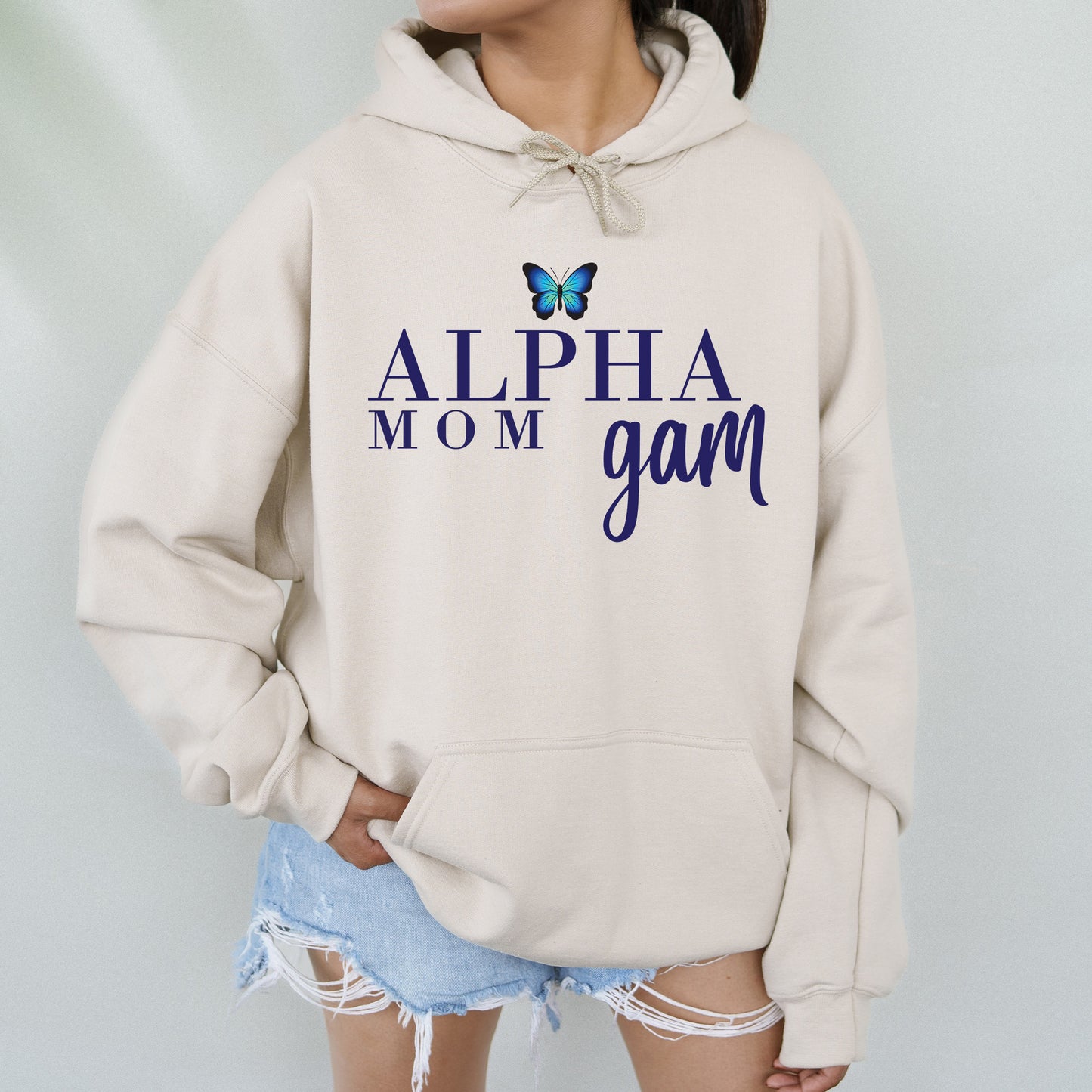 a woman wearing a sweatshirt that says,'alpha mom gam '