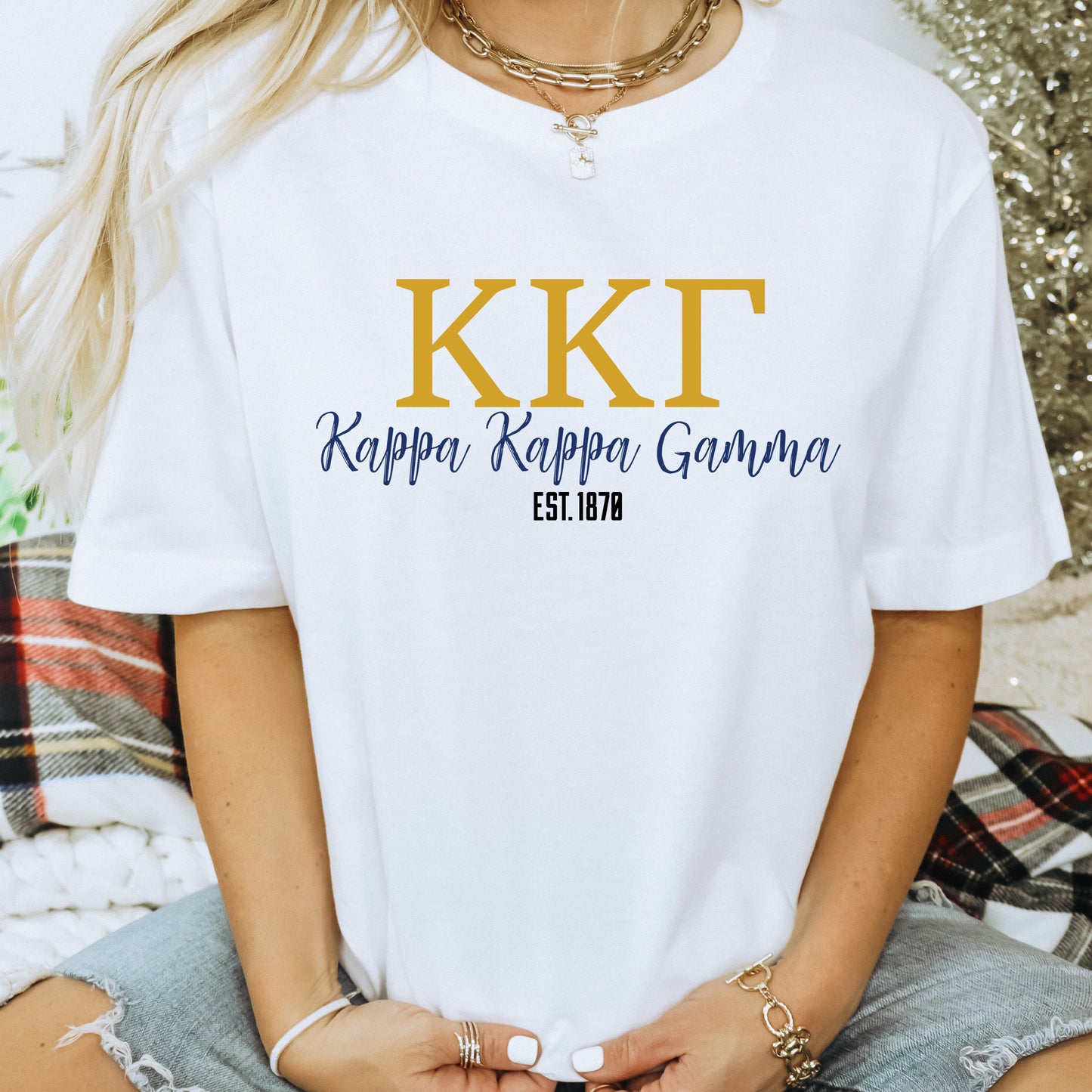 a woman wearing a white t - shirt with the words kkt on it