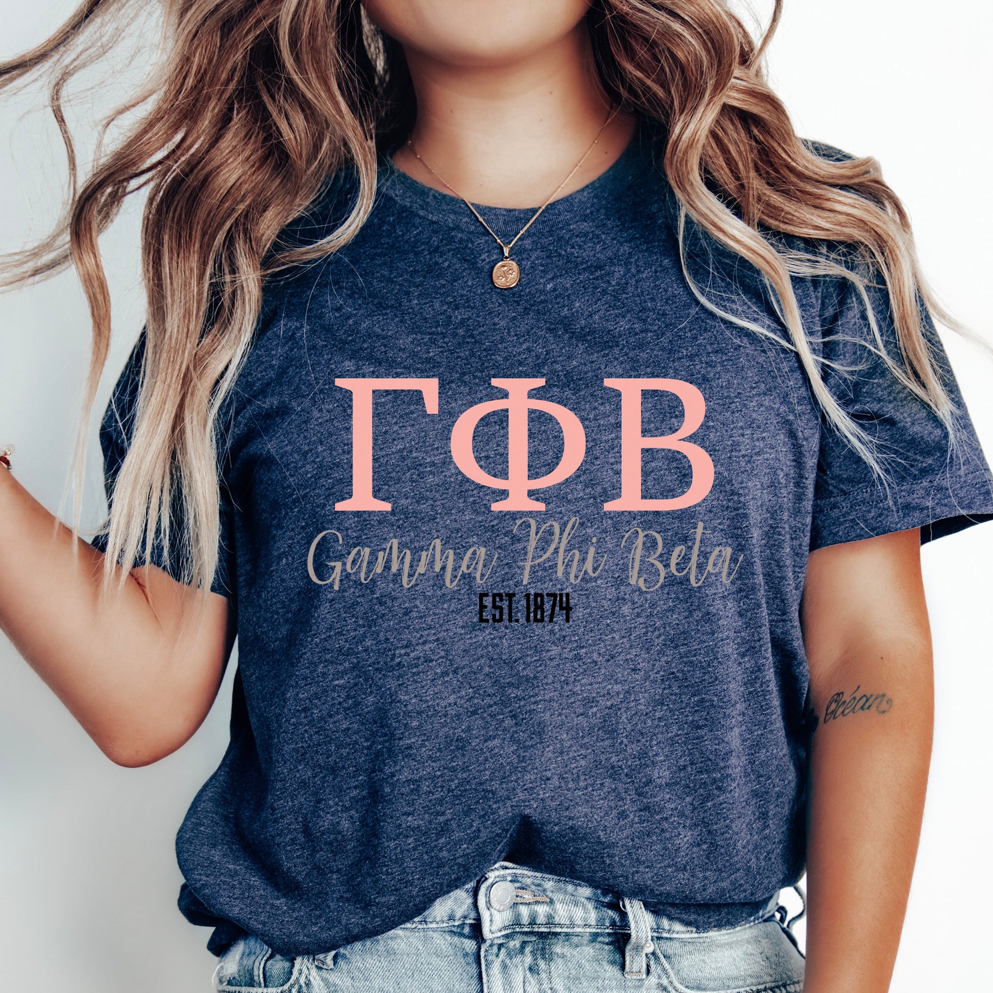 a woman wearing a t - shirt with the letters phi and phi on it