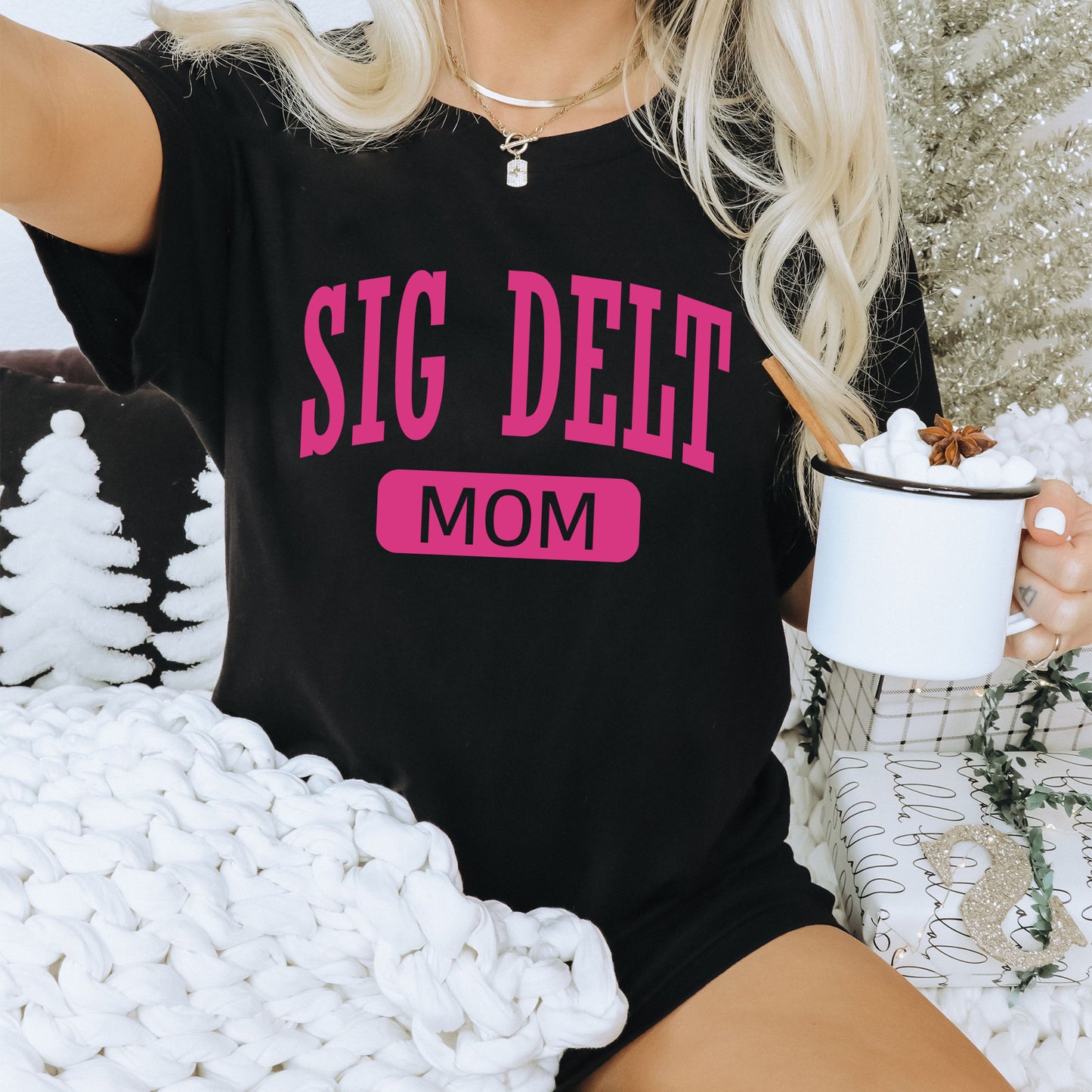 a woman sitting on a couch holding a cup of coffee