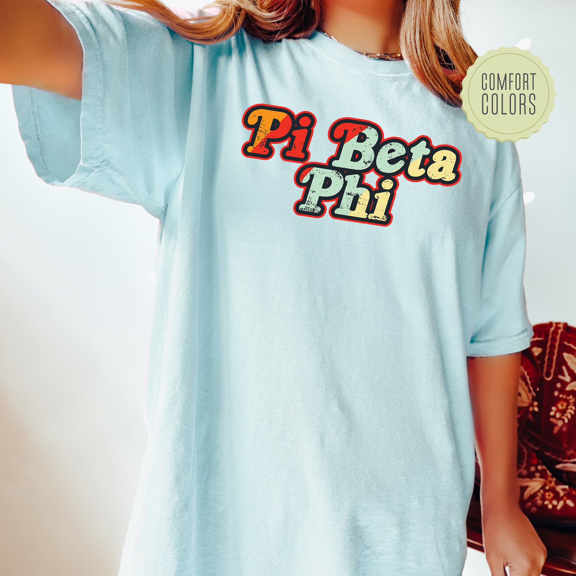 a woman wearing a pi beta phi t - shirt
