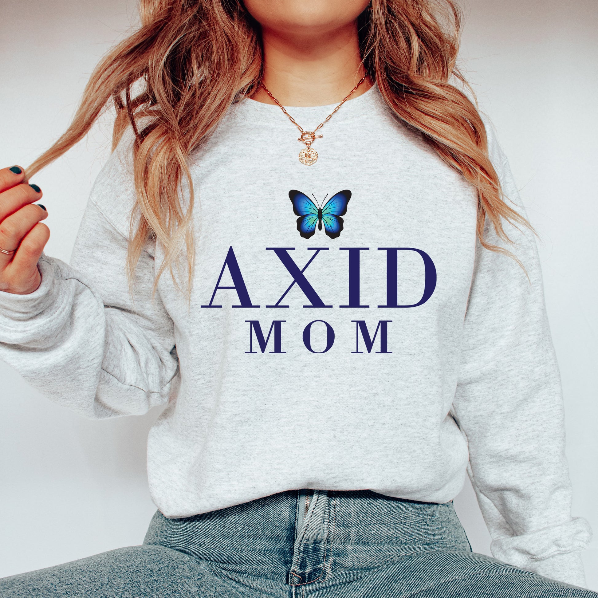 a woman wearing a sweatshirt with a butterfly on it