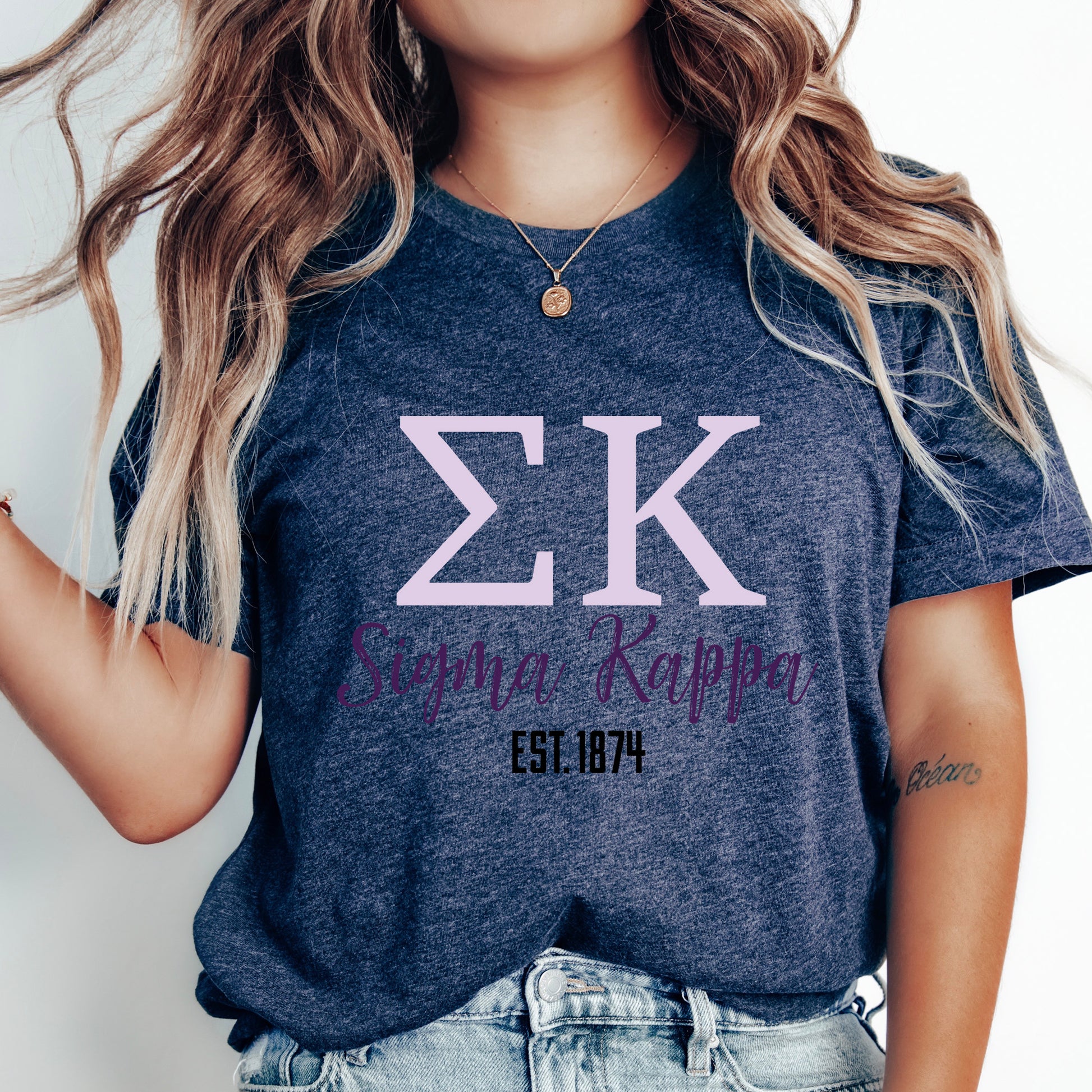a woman wearing a t - shirt with the letter k on it