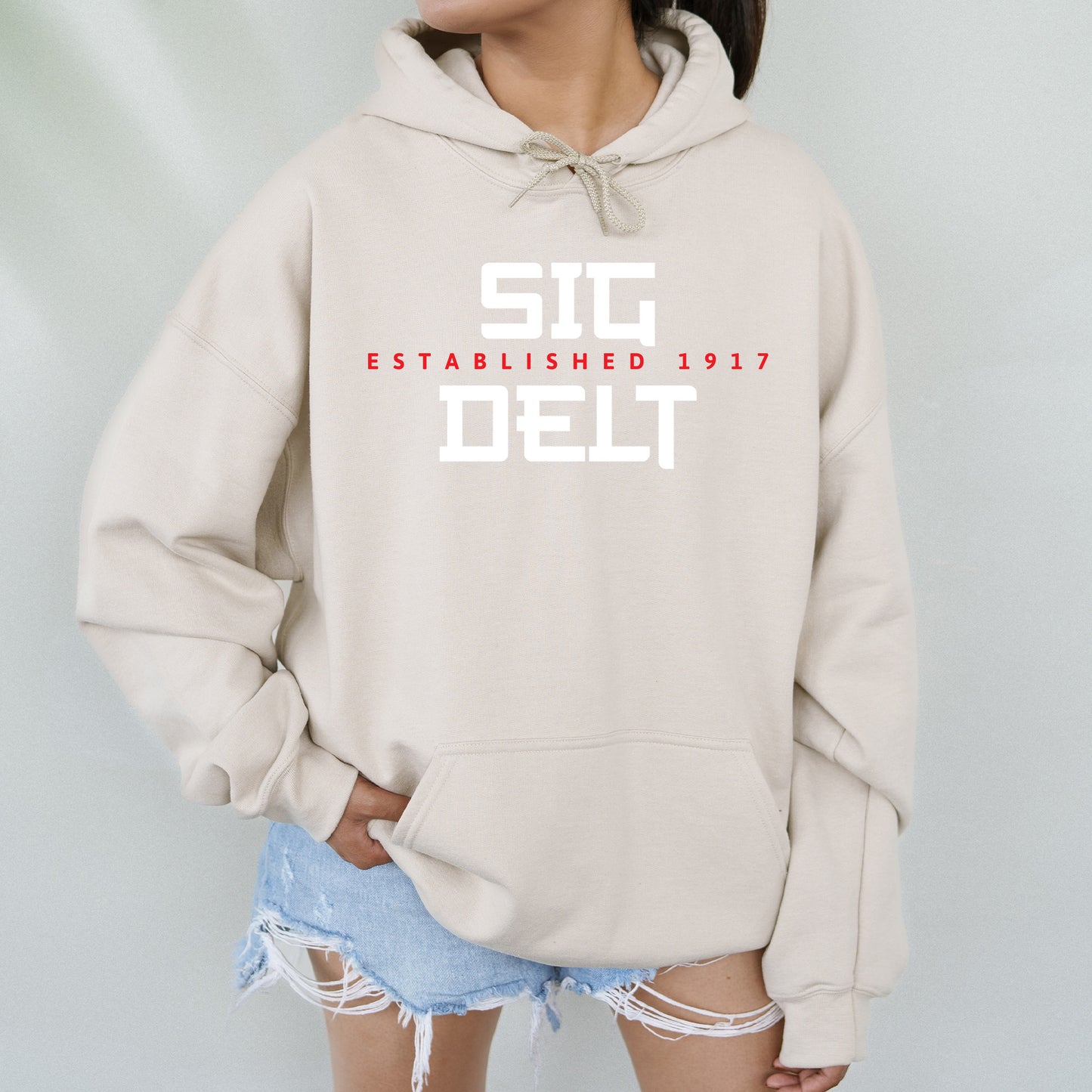 a woman wearing a sweatshirt that says stc established 1917