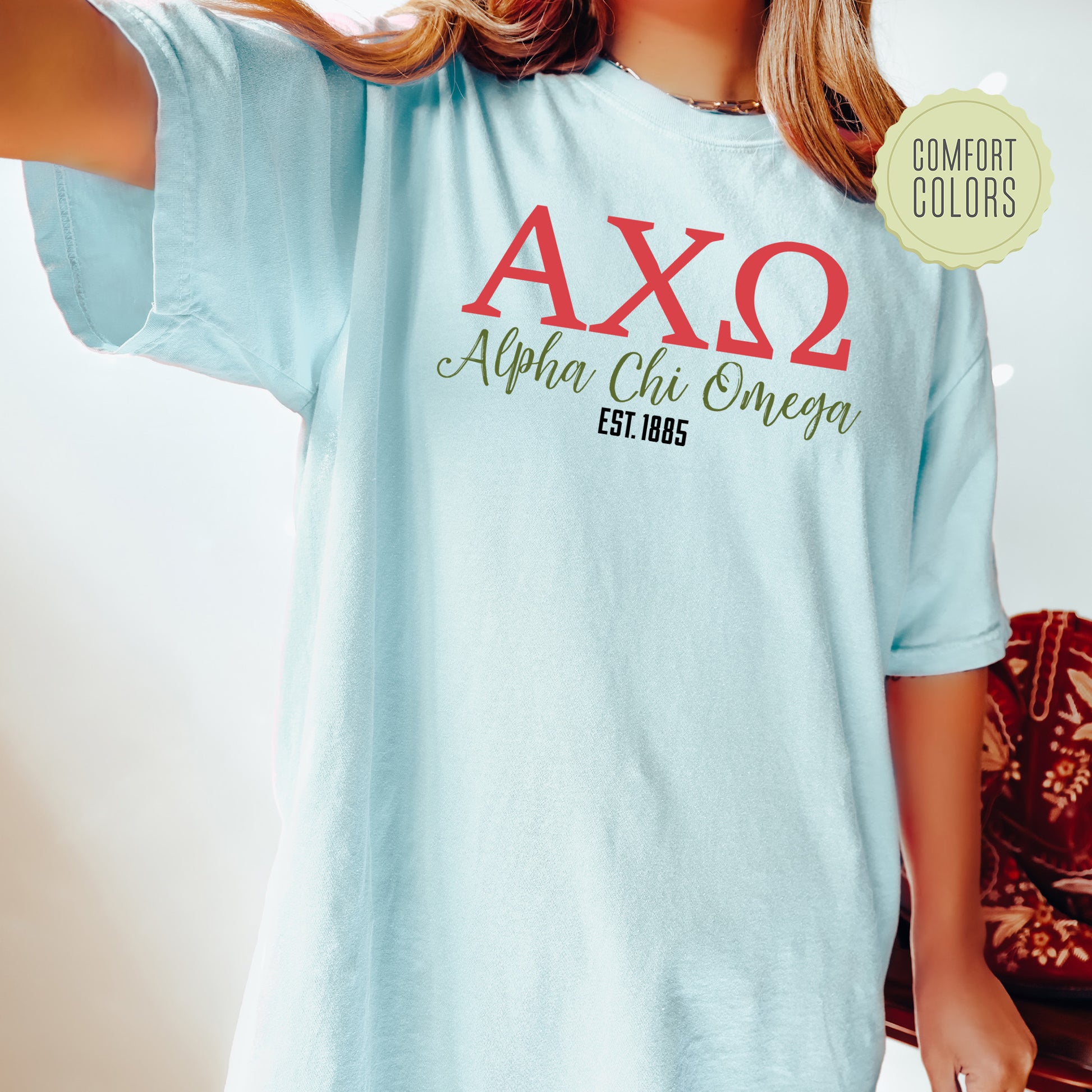 a woman wearing a light blue shirt with the ax2 logo on it