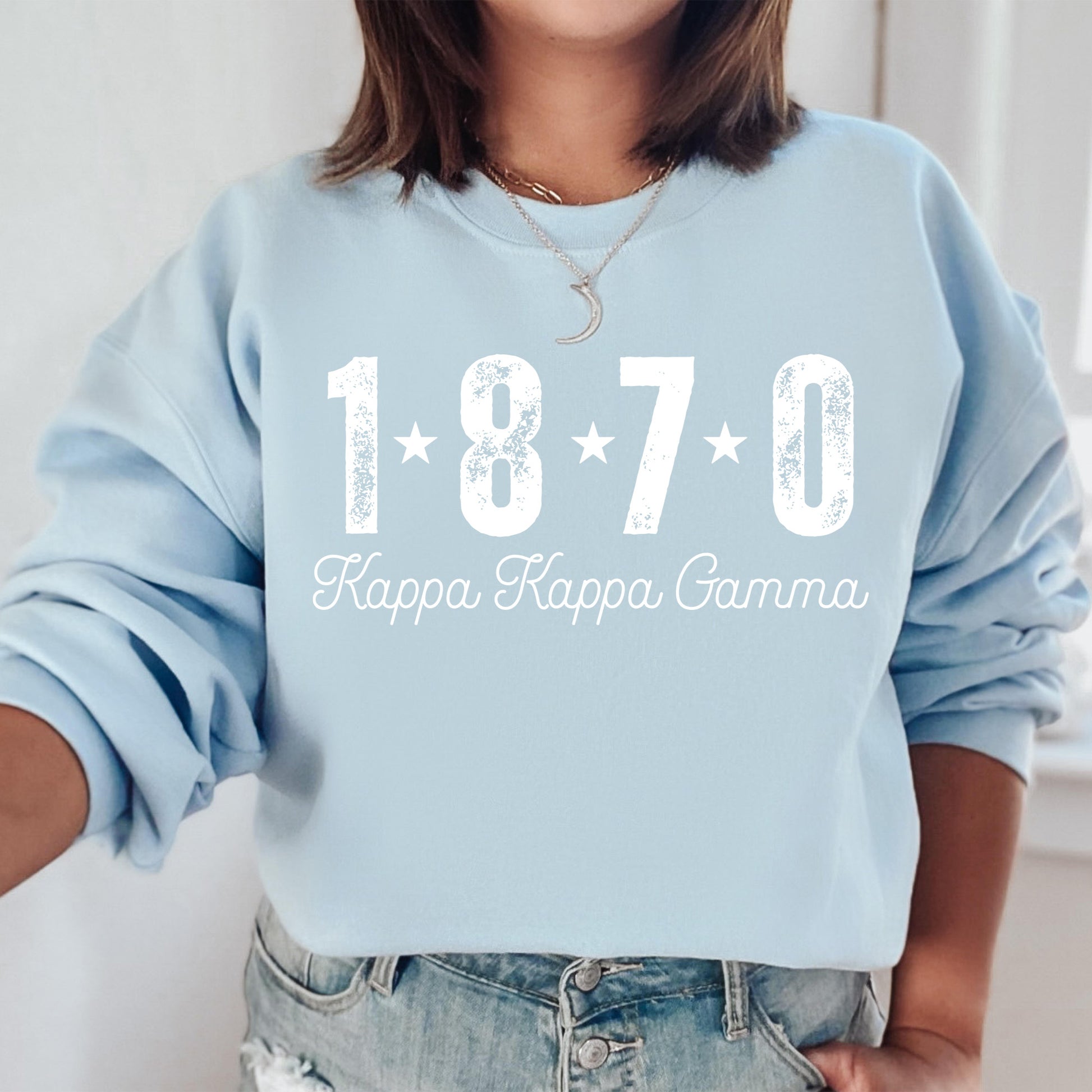 a woman wearing a blue sweatshirt that says happy happy grandma