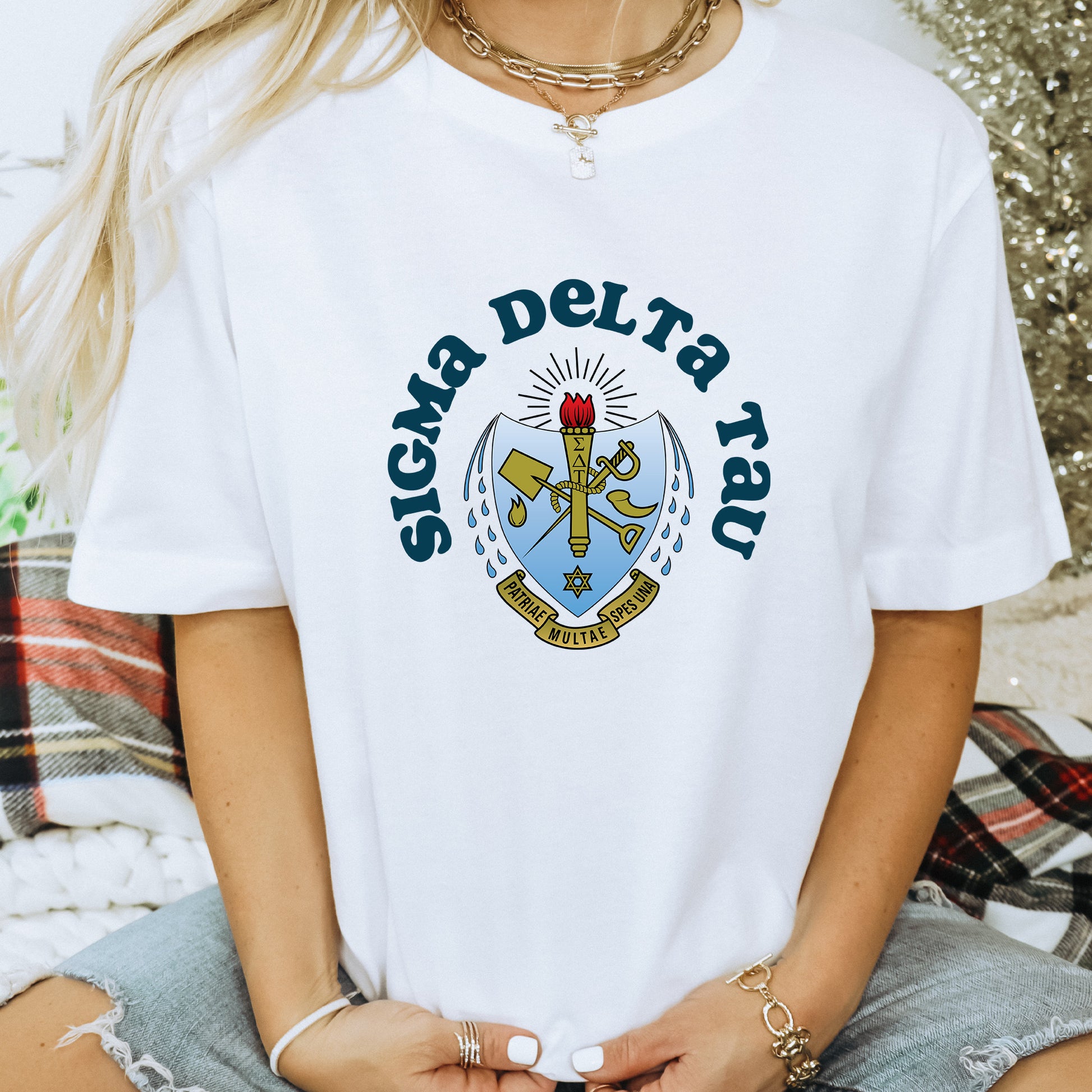 a woman wearing a white t - shirt with a cross on it