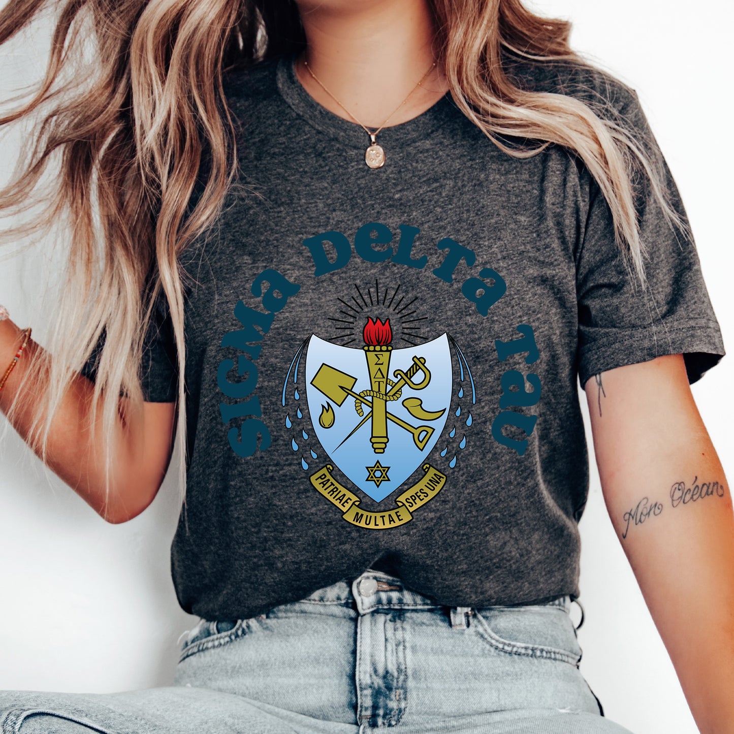 a woman wearing a t - shirt with a coat of arms on it