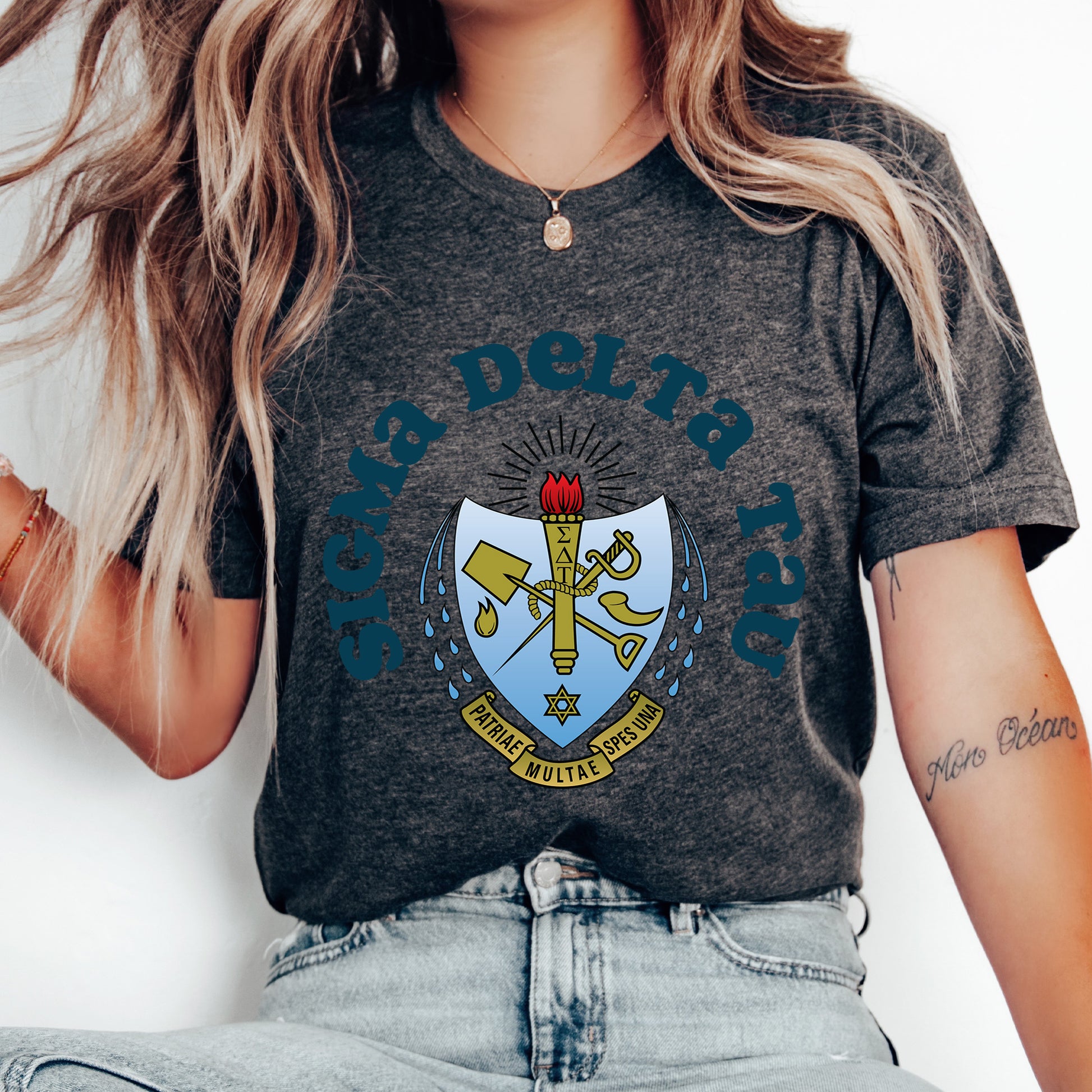 a woman wearing a t - shirt with a coat of arms on it