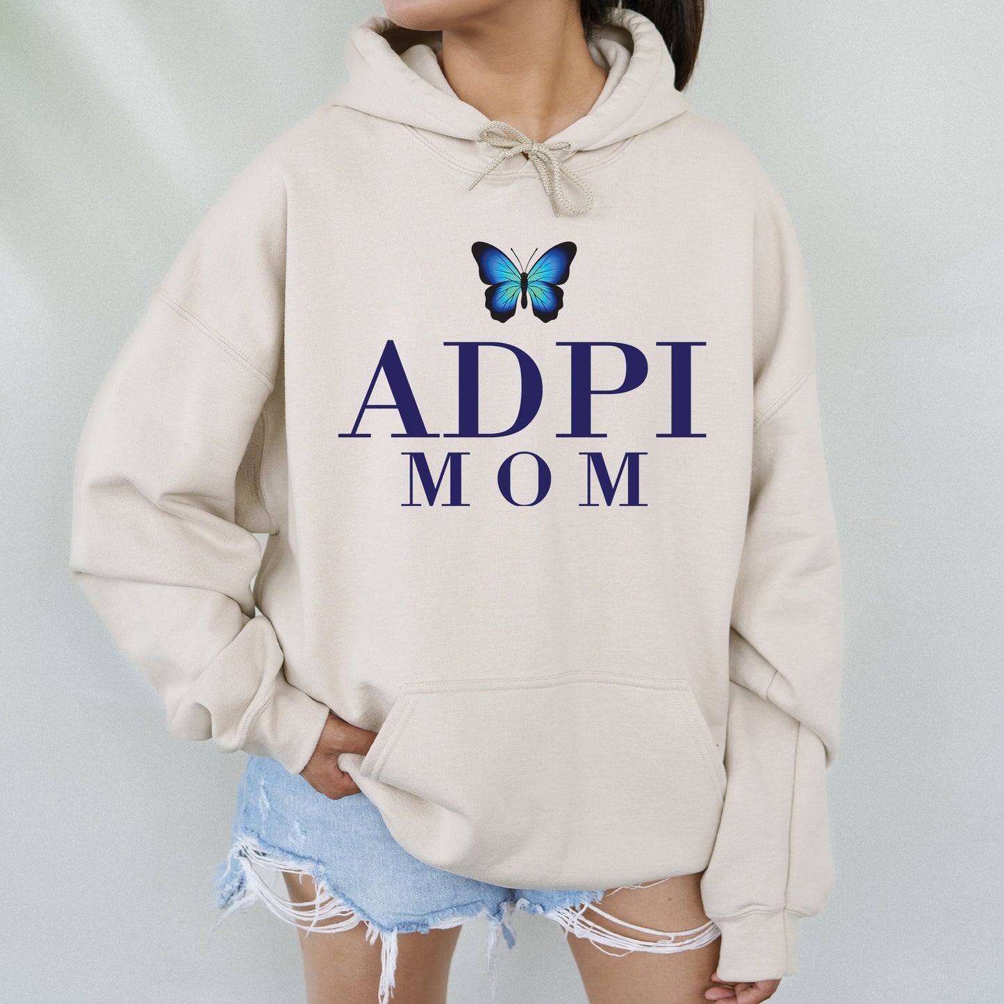 a woman wearing a sweatshirt with a butterfly on it