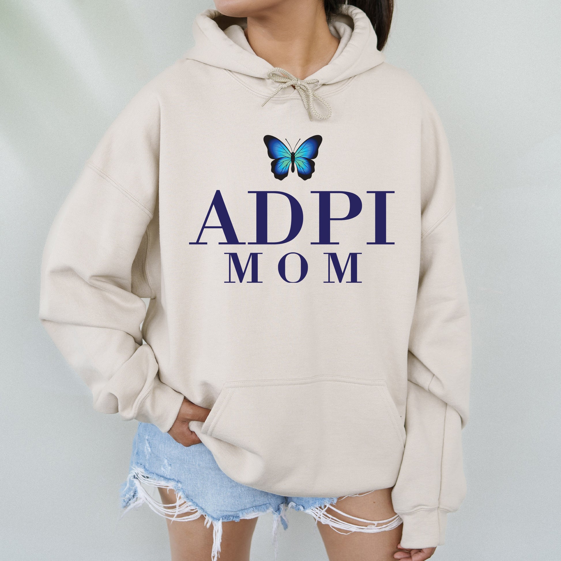 a woman wearing a sweatshirt with a butterfly on it
