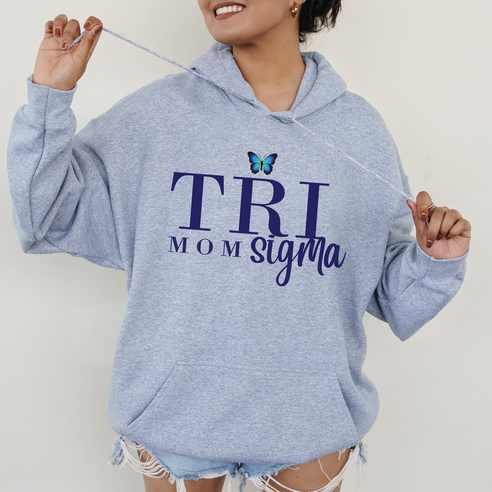 a woman in a blue hoodie holding a toothbrush