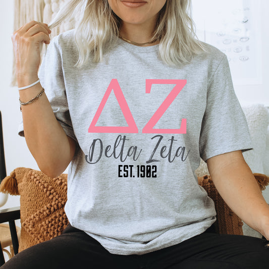 a woman sitting on a chair wearing a delta delta shirt