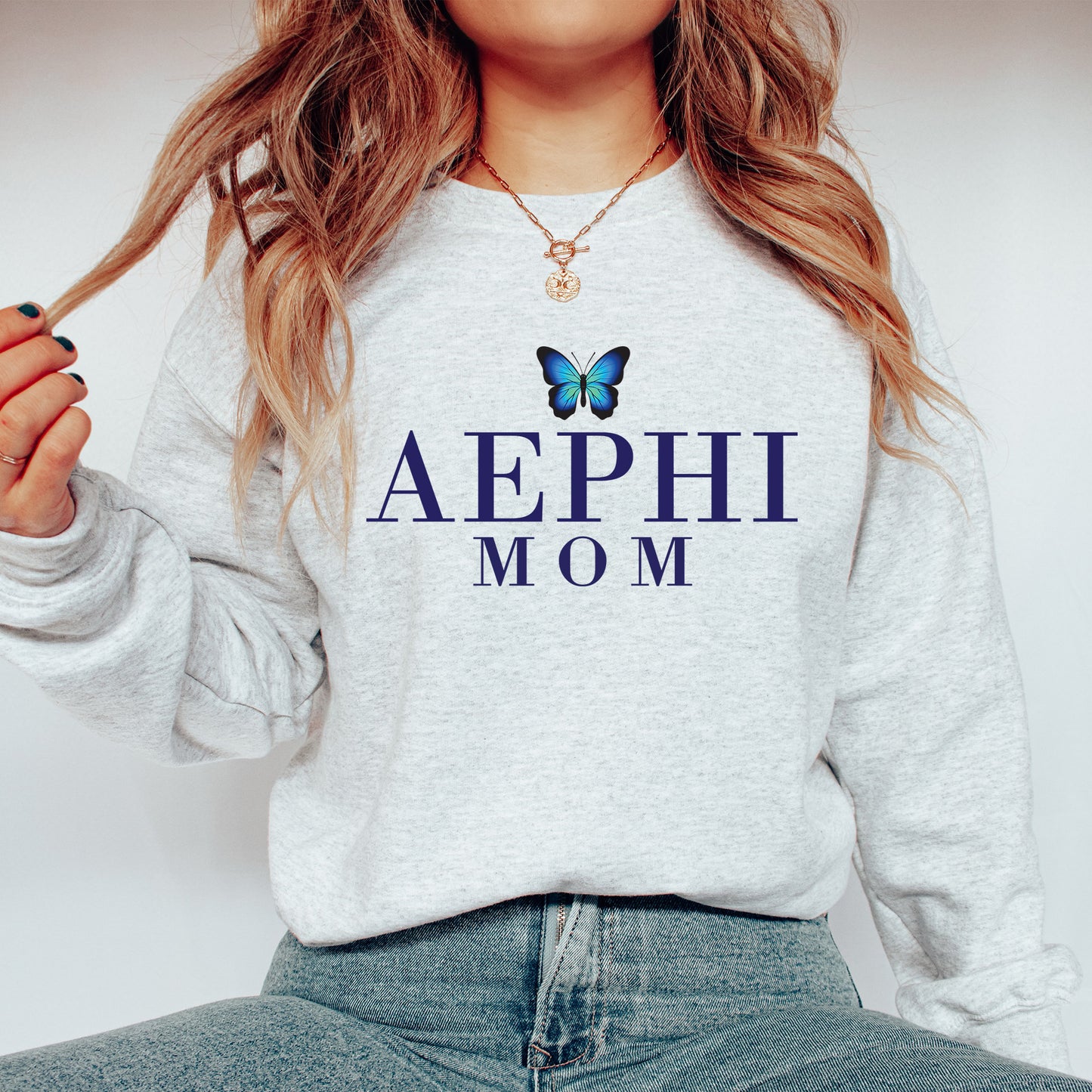 a woman wearing a sweatshirt with a butterfly on it