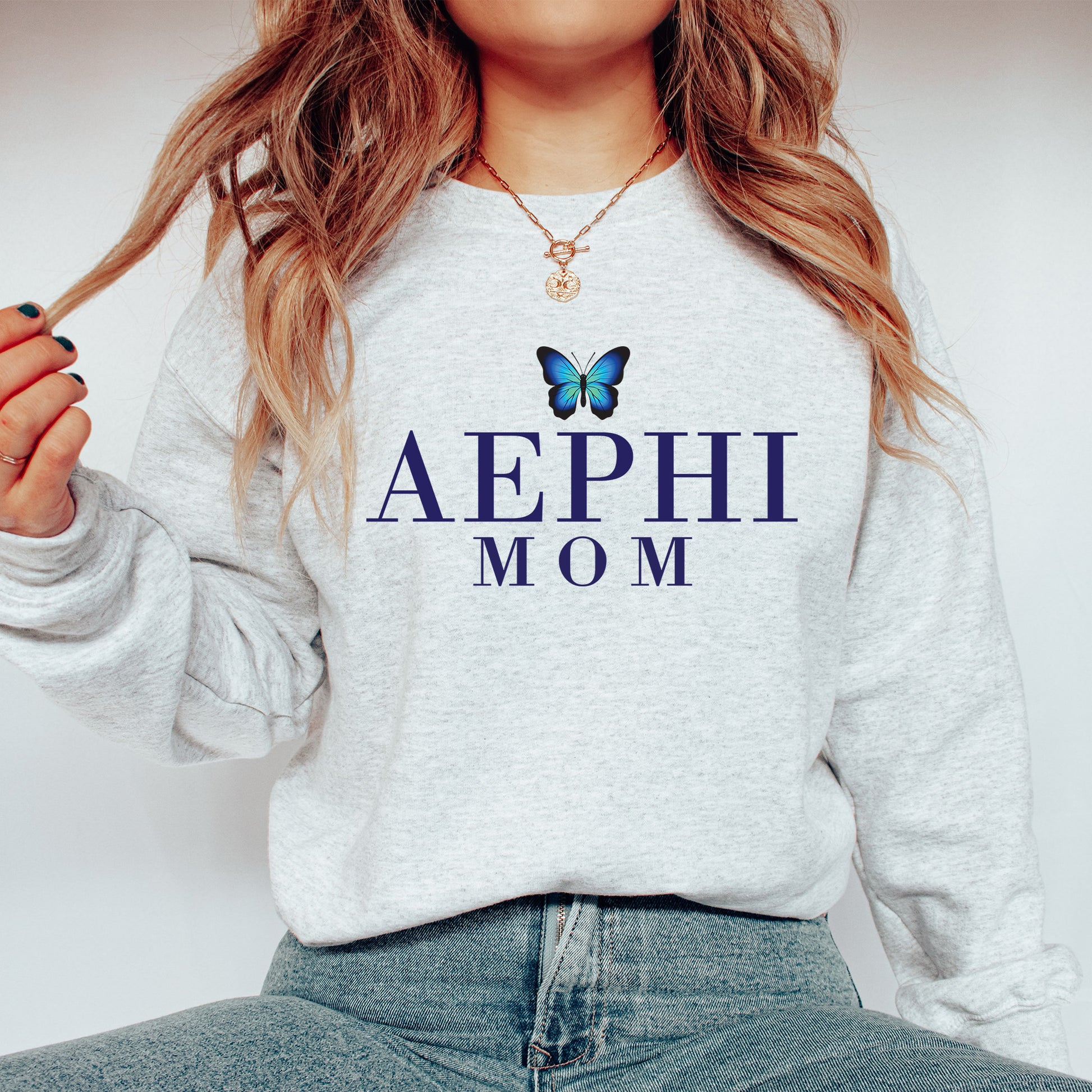 a woman wearing a sweatshirt with a butterfly on it