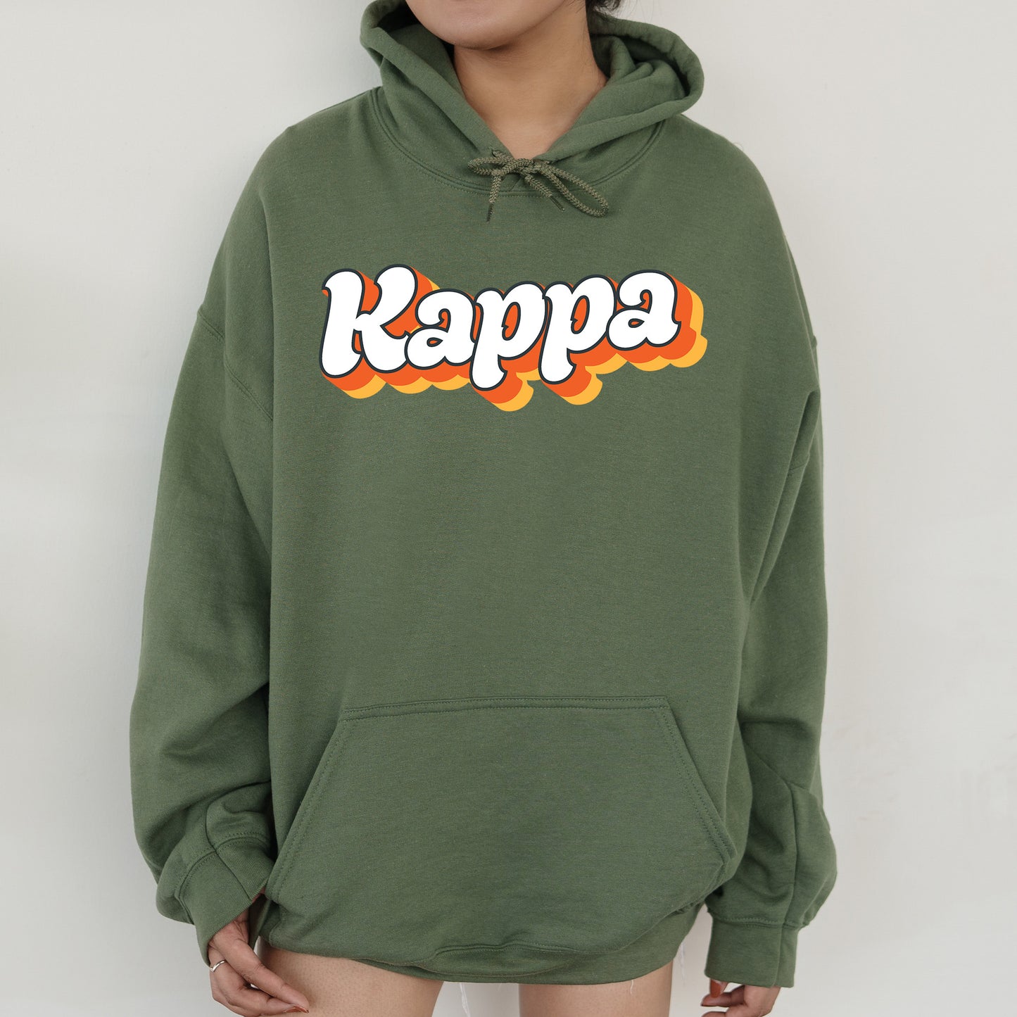 a person wearing a green hoodie with the word kappa on it