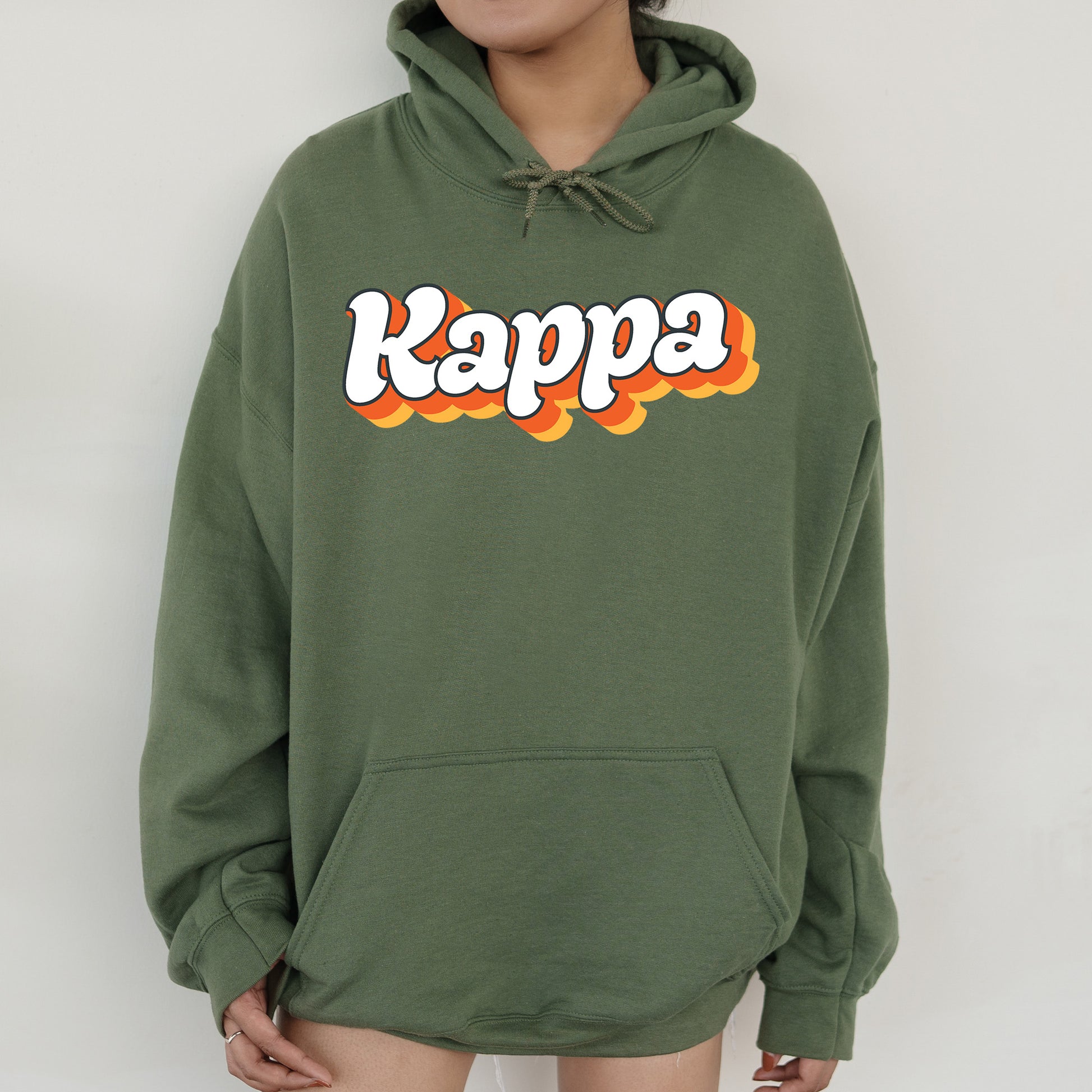 a person wearing a green hoodie with the word kappa on it
