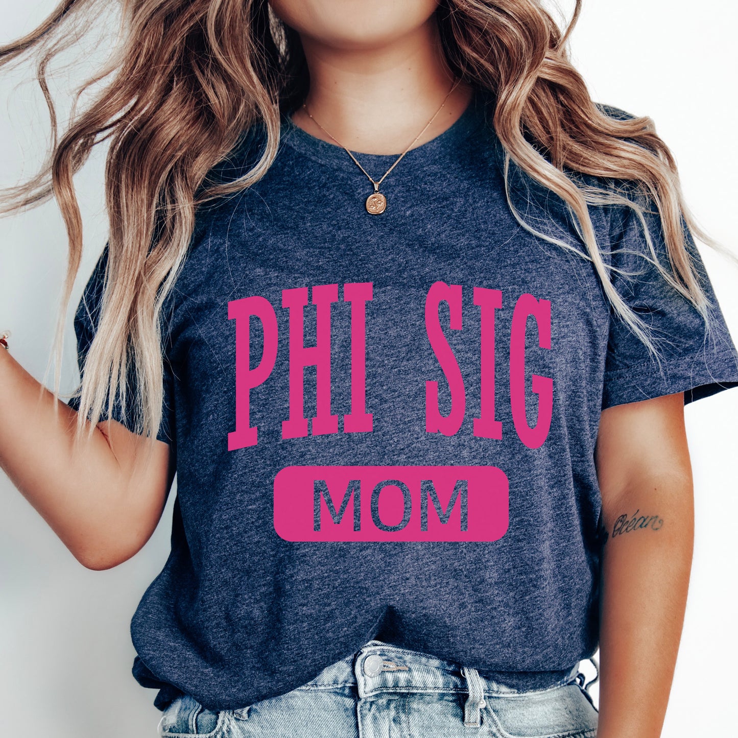 a woman wearing a phi sig mom shirt