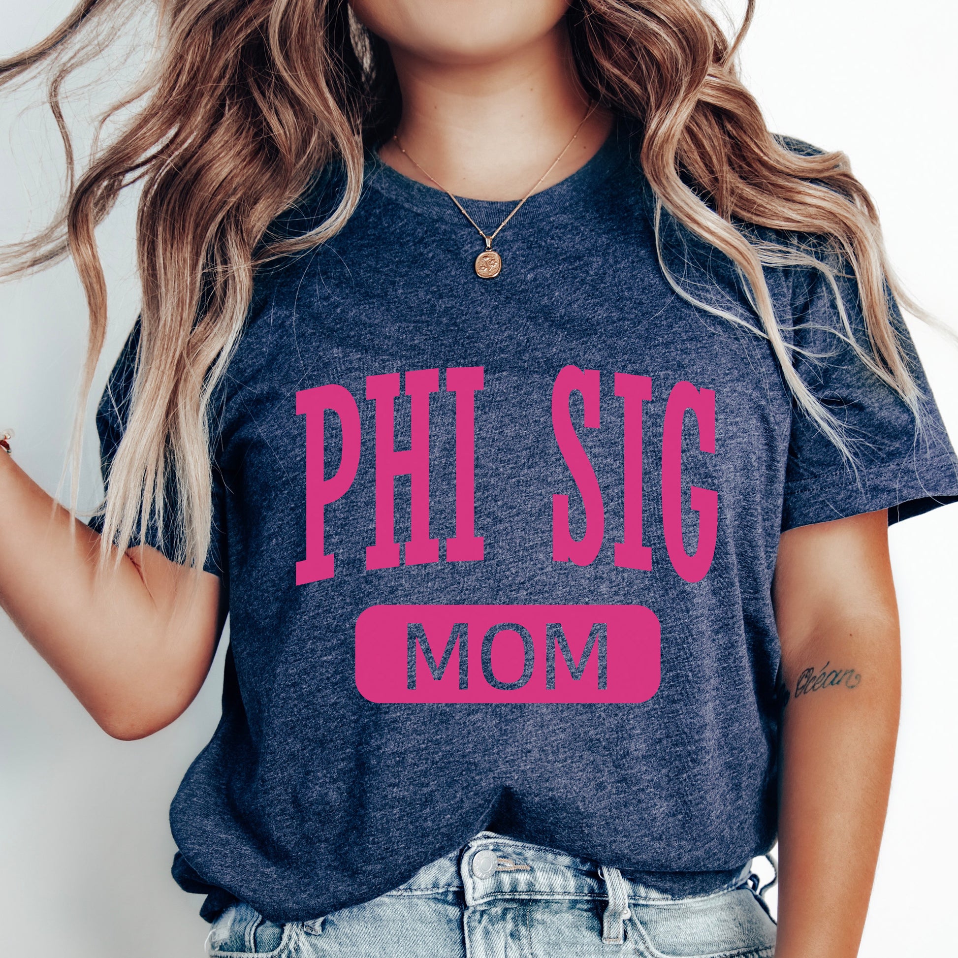 a woman wearing a phi sig mom shirt