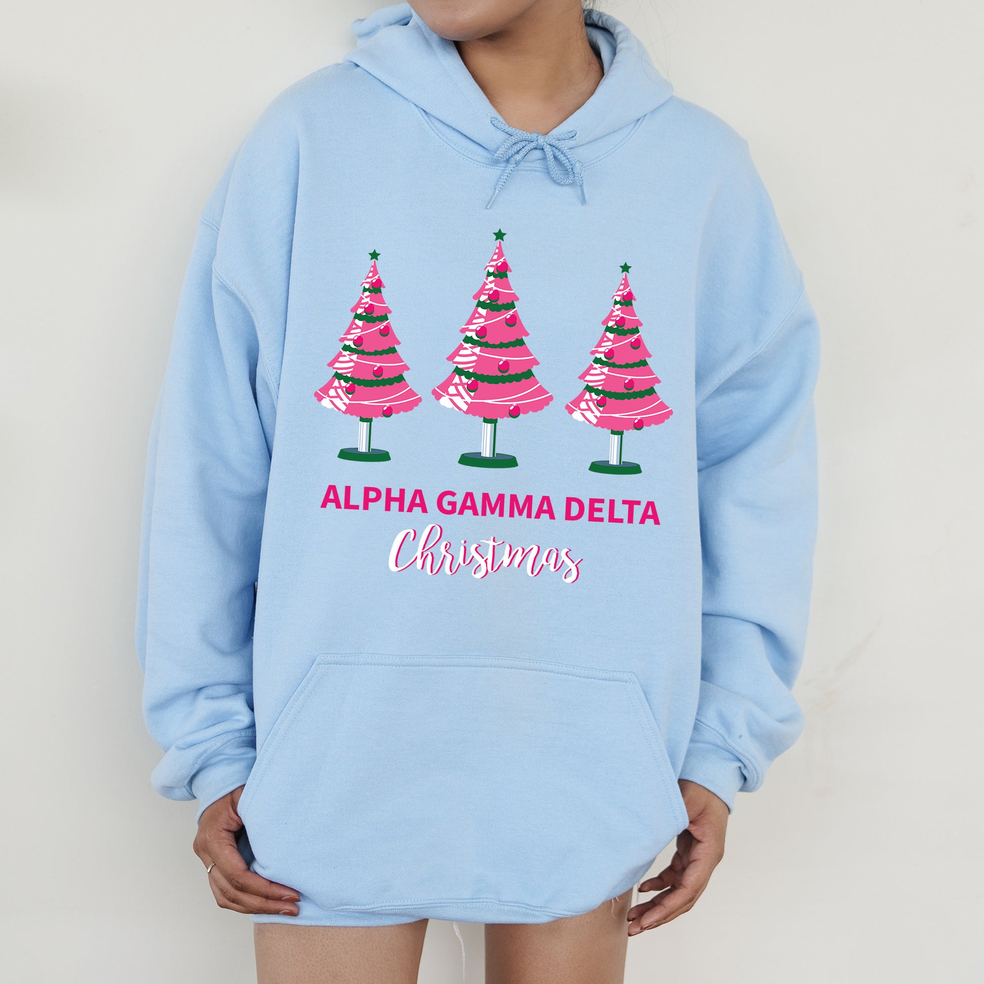 a person wearing a blue hoodie with christmas trees on it