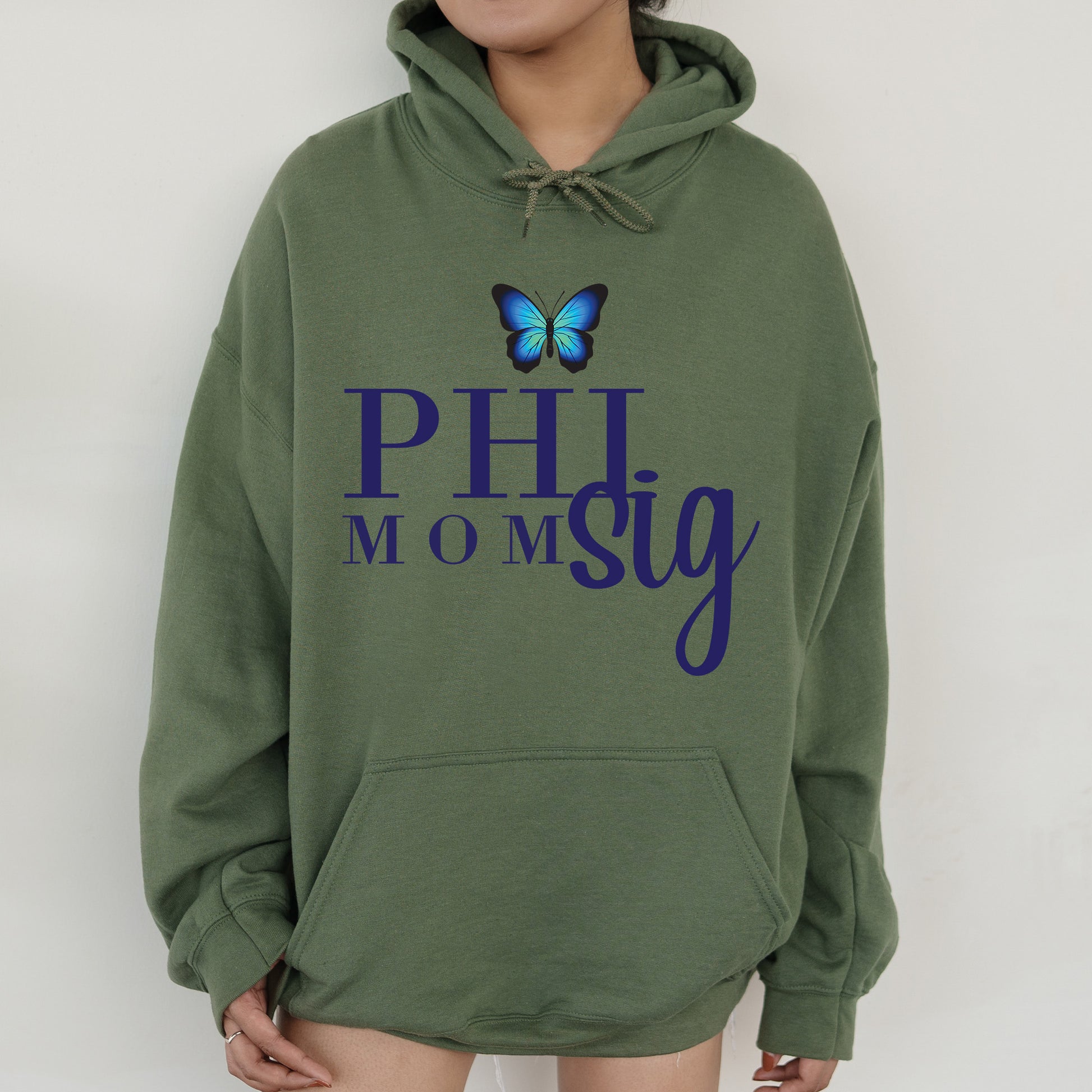 a woman wearing a green hoodie with a blue butterfly on it