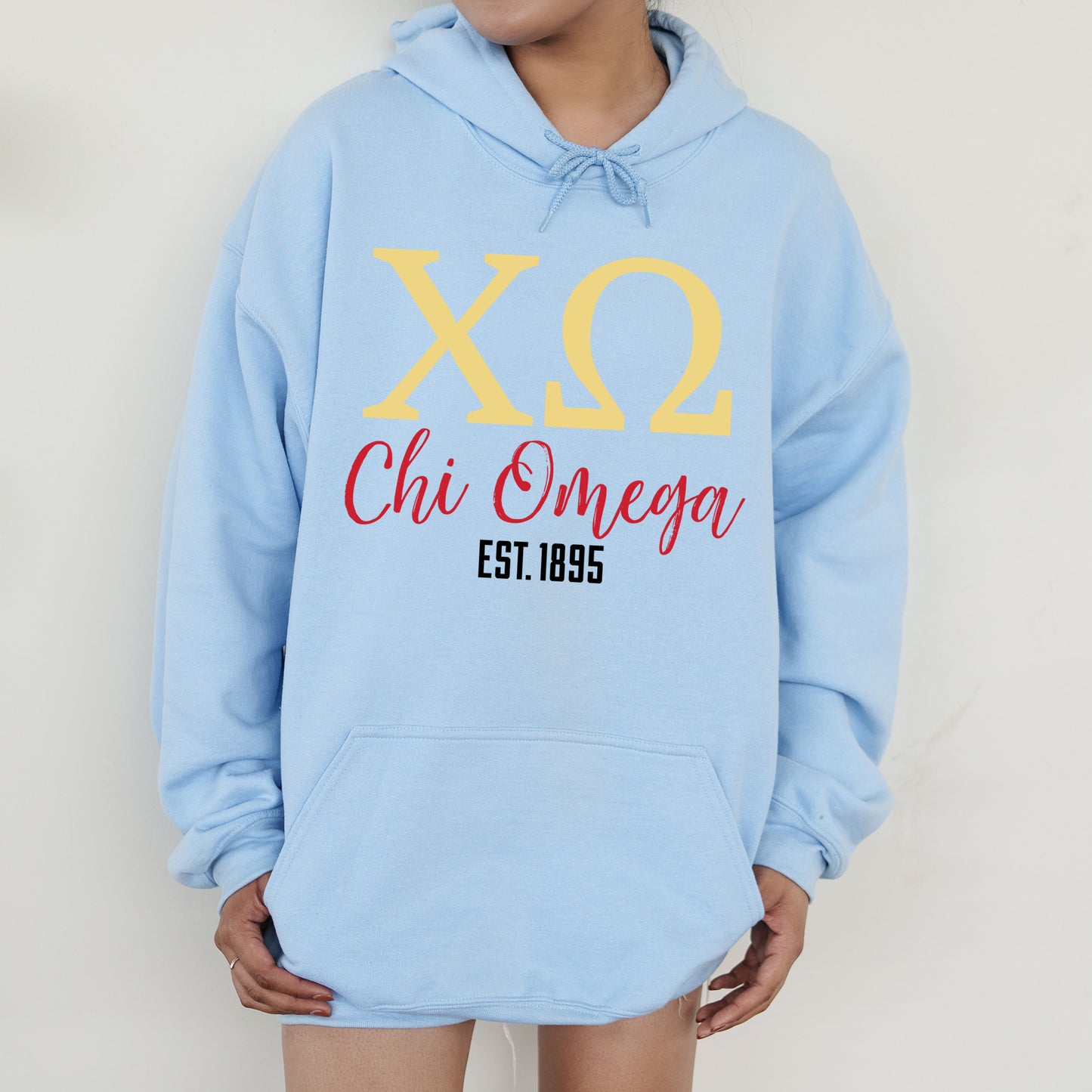 a person wearing a blue hoodie with a yellow xo on it
