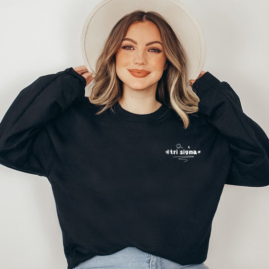 a woman wearing a black sweatshirt and a white hat