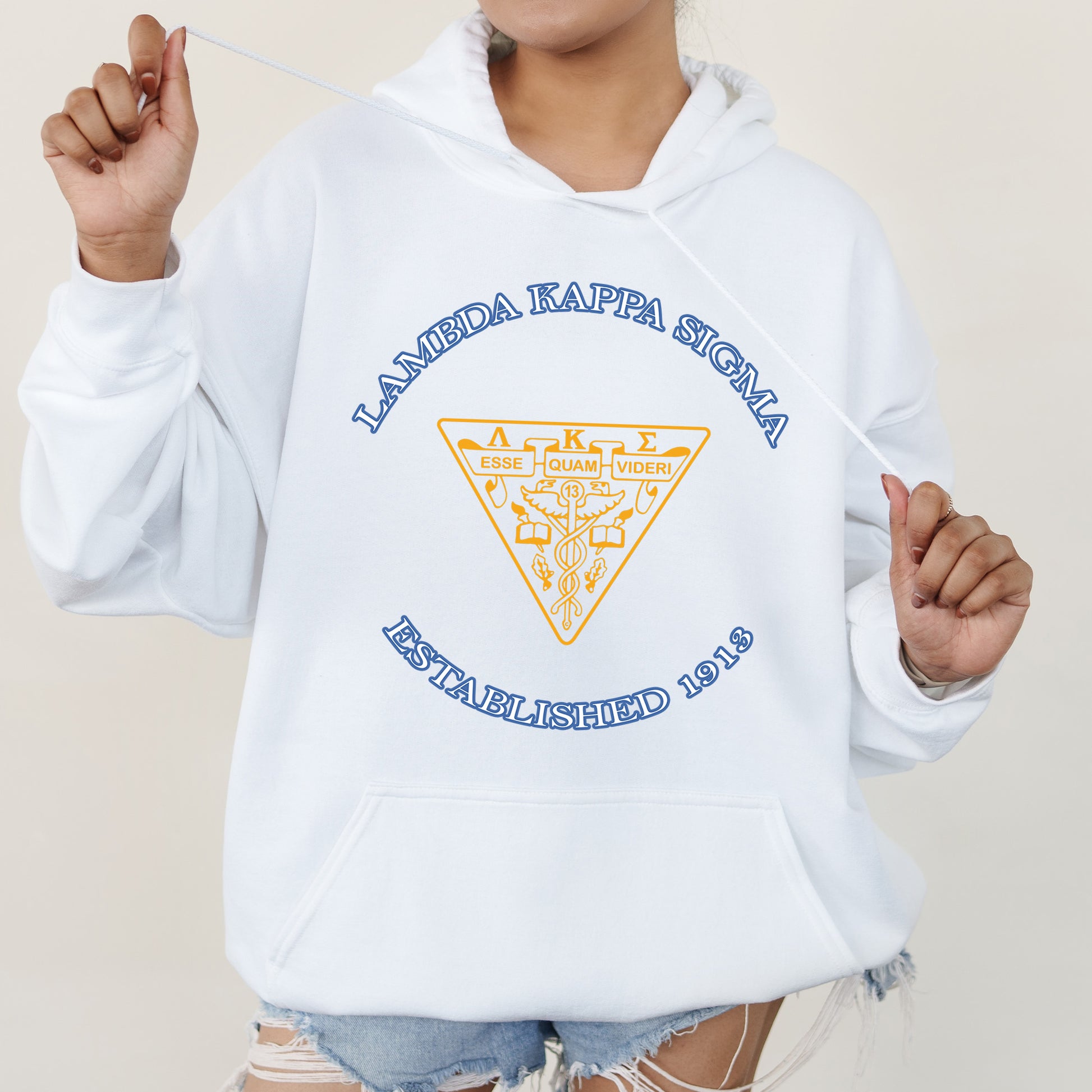 a woman wearing a white hoodie with a triangle on it