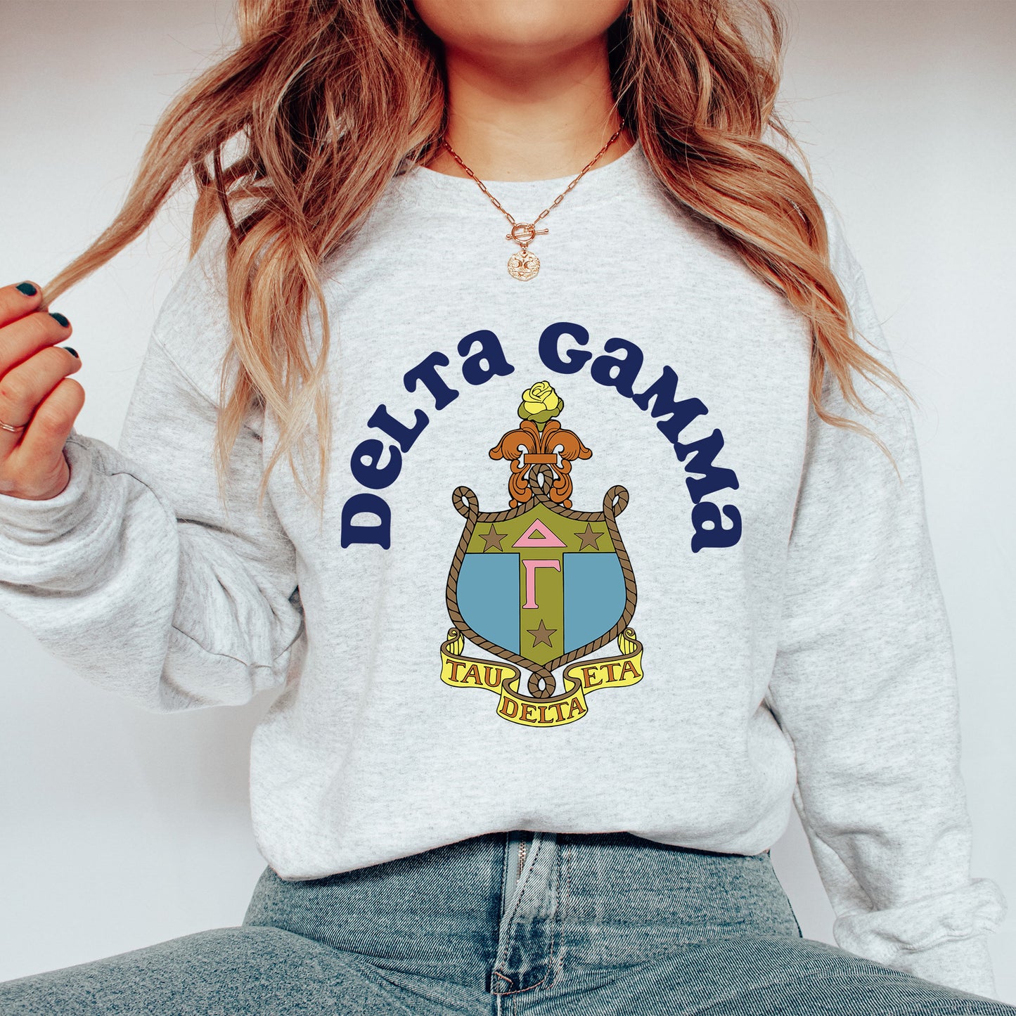 a woman wearing a sweatshirt that says delta gama