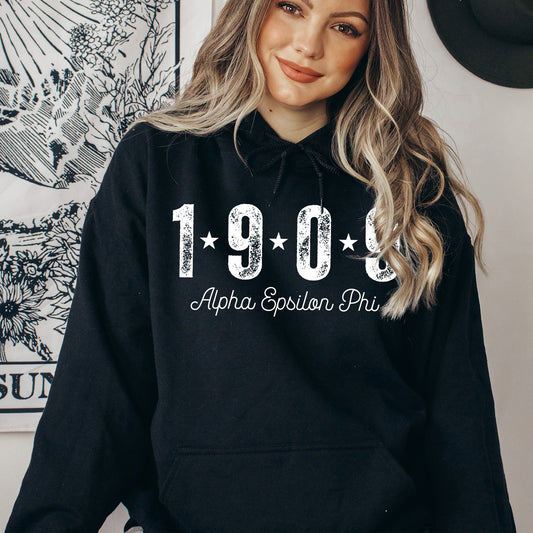 a woman wearing a black sweatshirt with the year 1994 printed on it