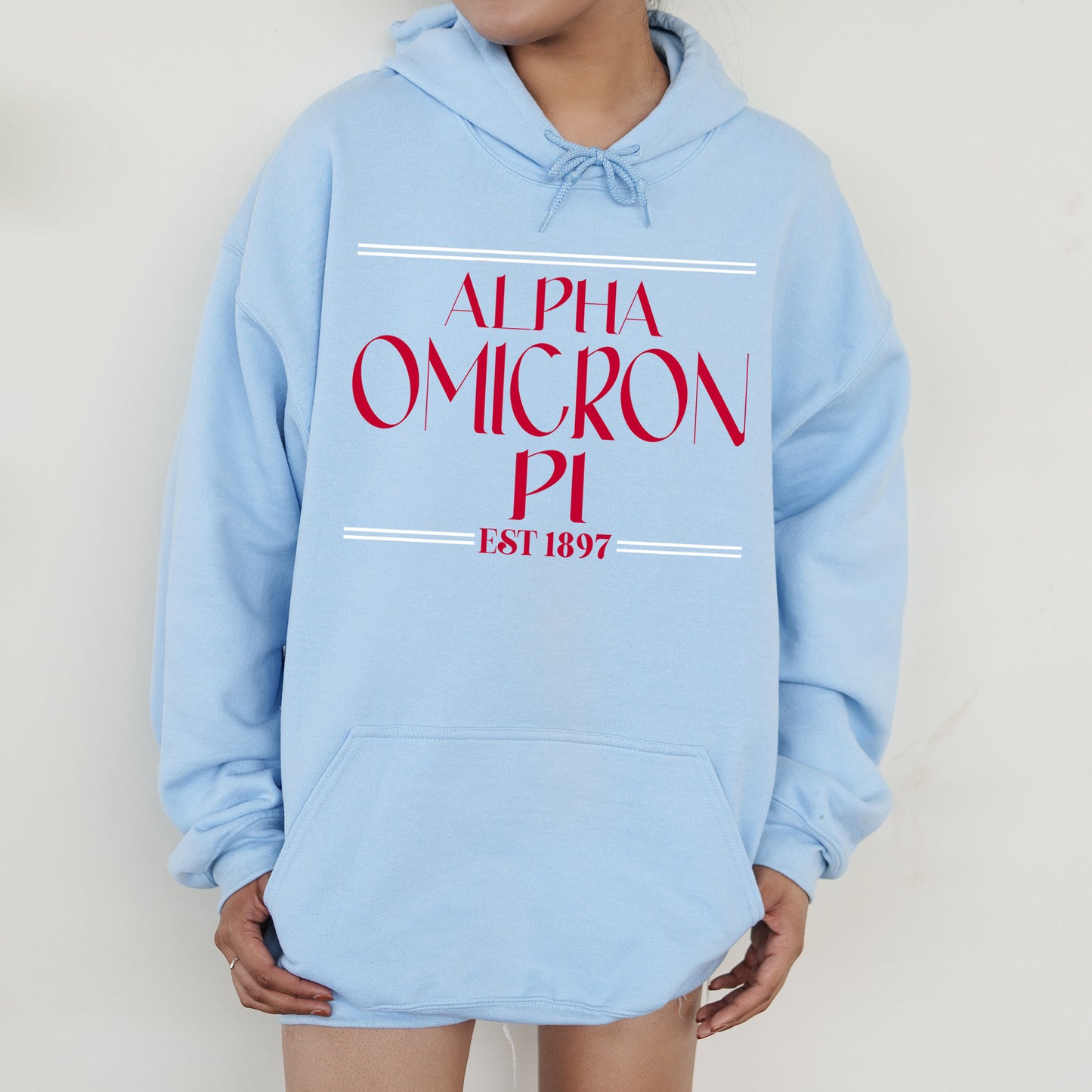 a person wearing a blue sweatshirt with a red and white logo on it