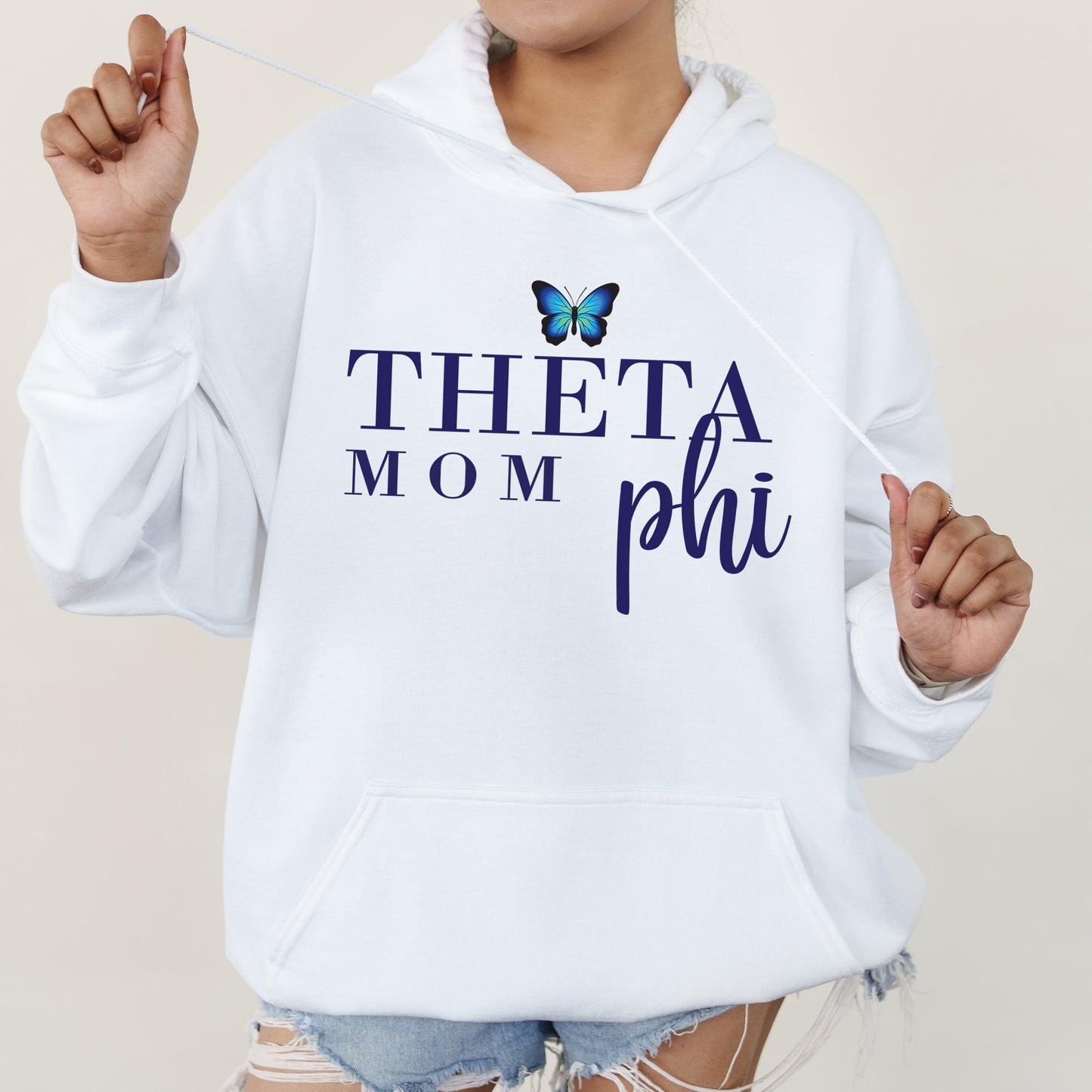 a woman in a white hoodie with a butterfly on it