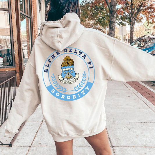 a woman in a white hoodie is walking down the street