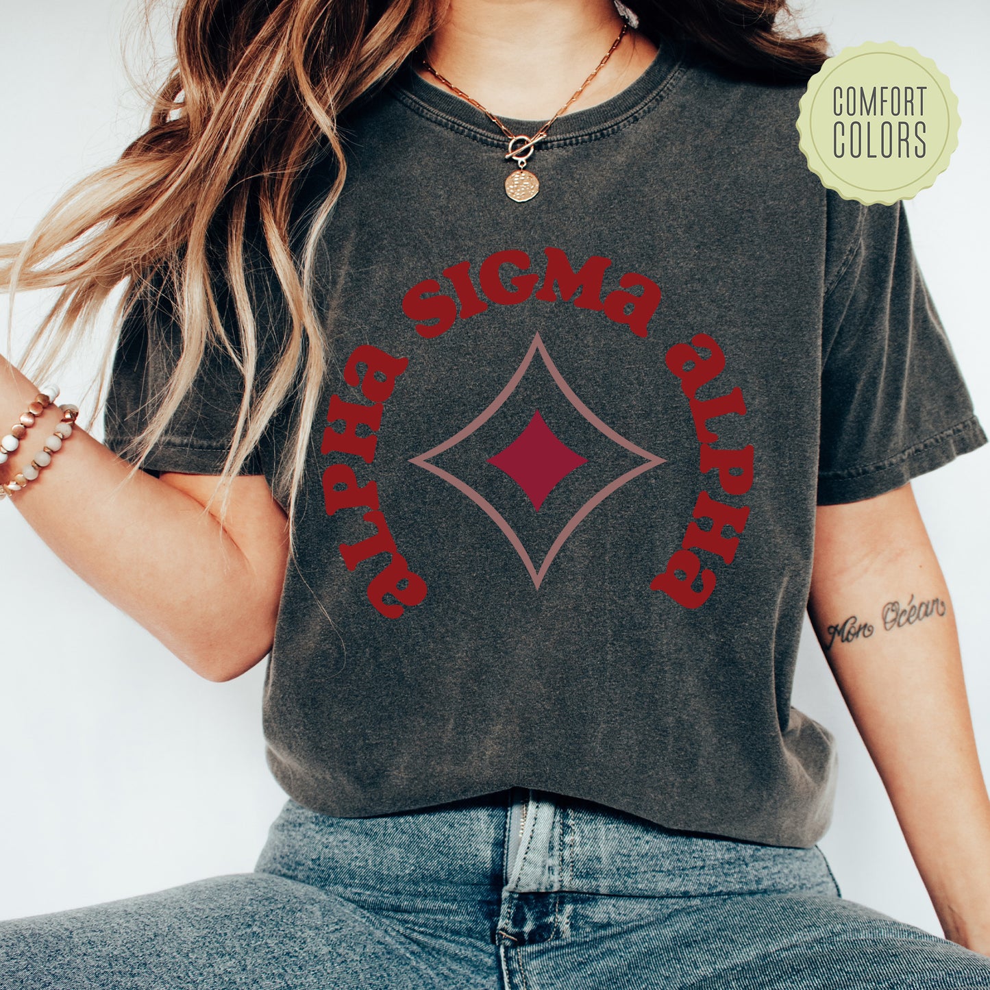 a woman wearing a black shirt with a red diamond on it