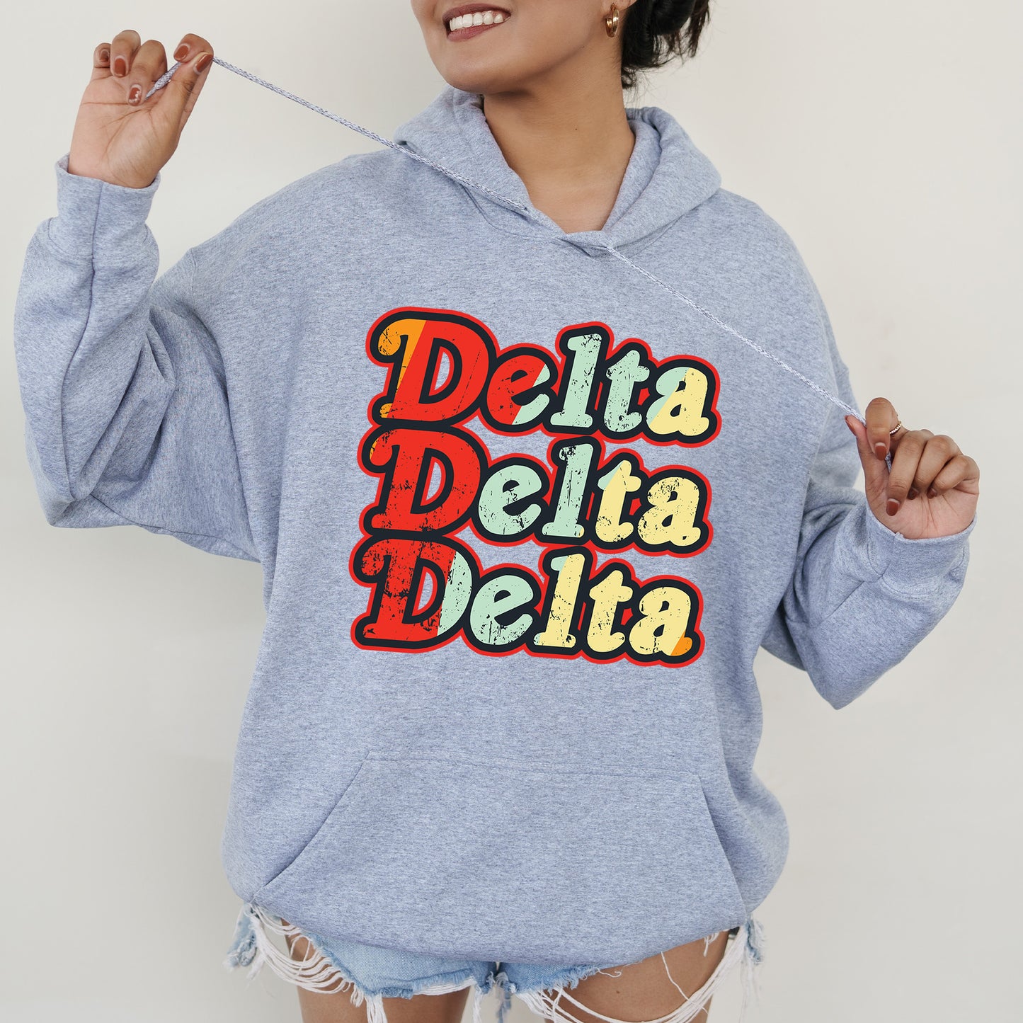 a woman wearing a blue sweatshirt with the words delta delta on it