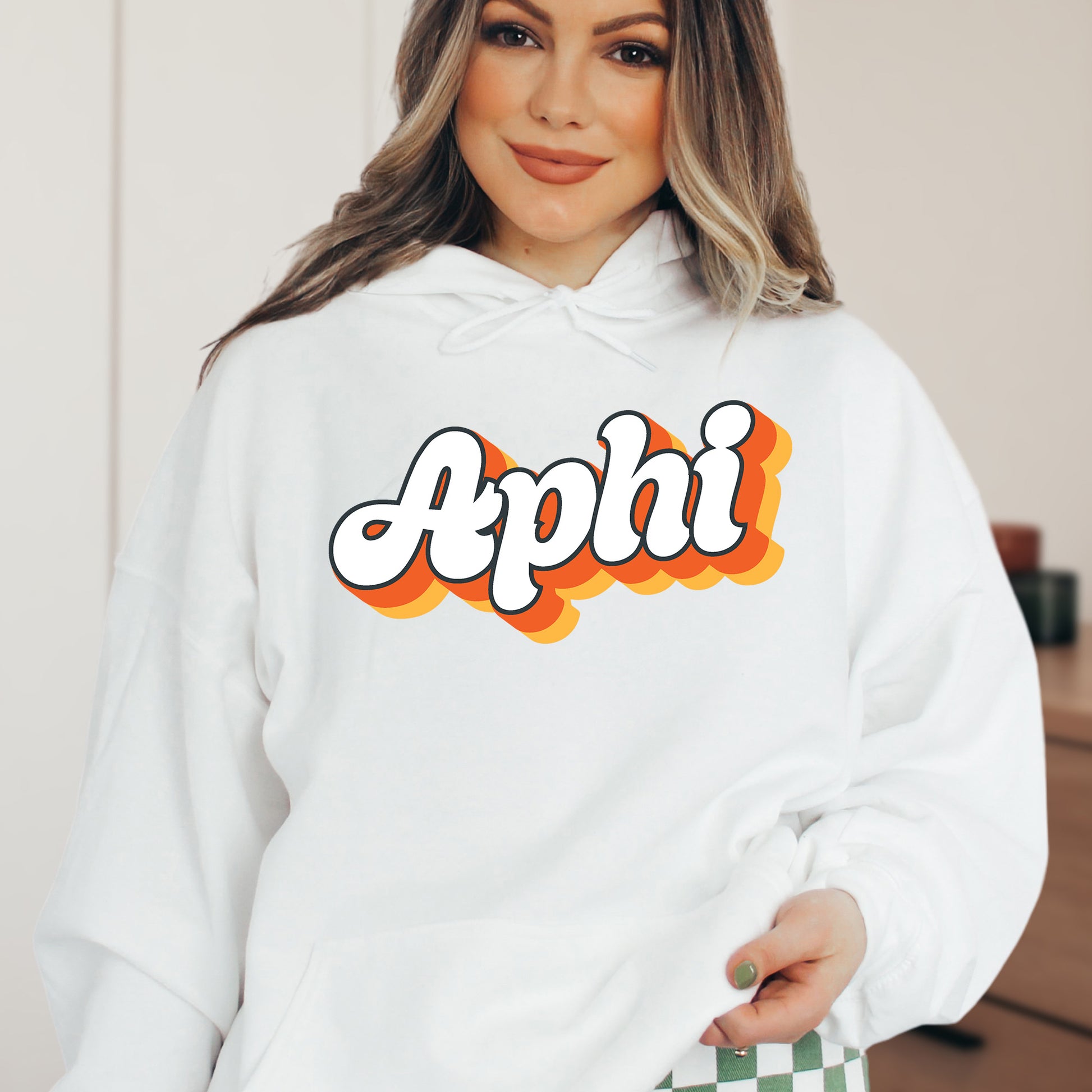 a woman wearing a white hoodie with the word apphi printed on it