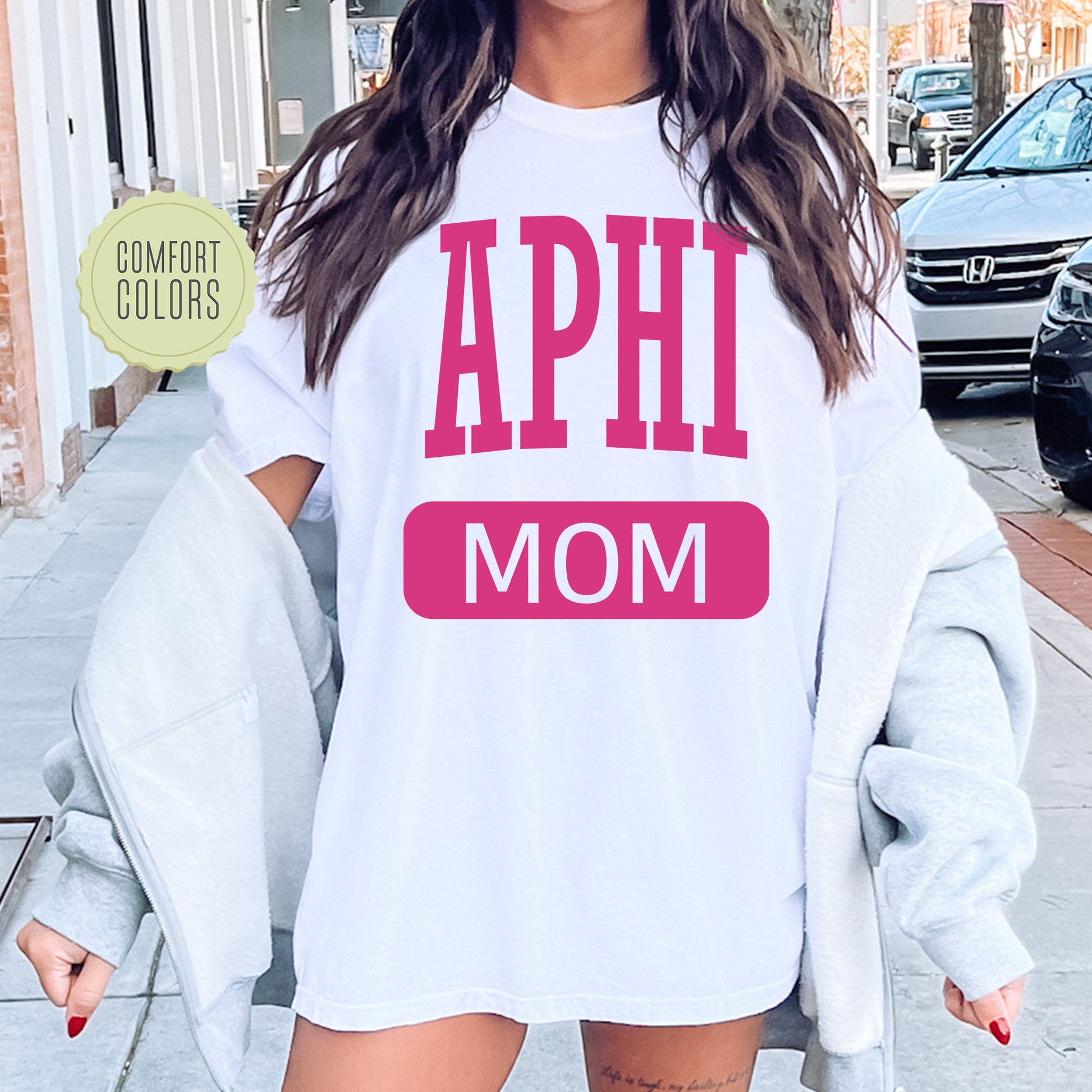 a woman wearing a shirt that says aphi mom