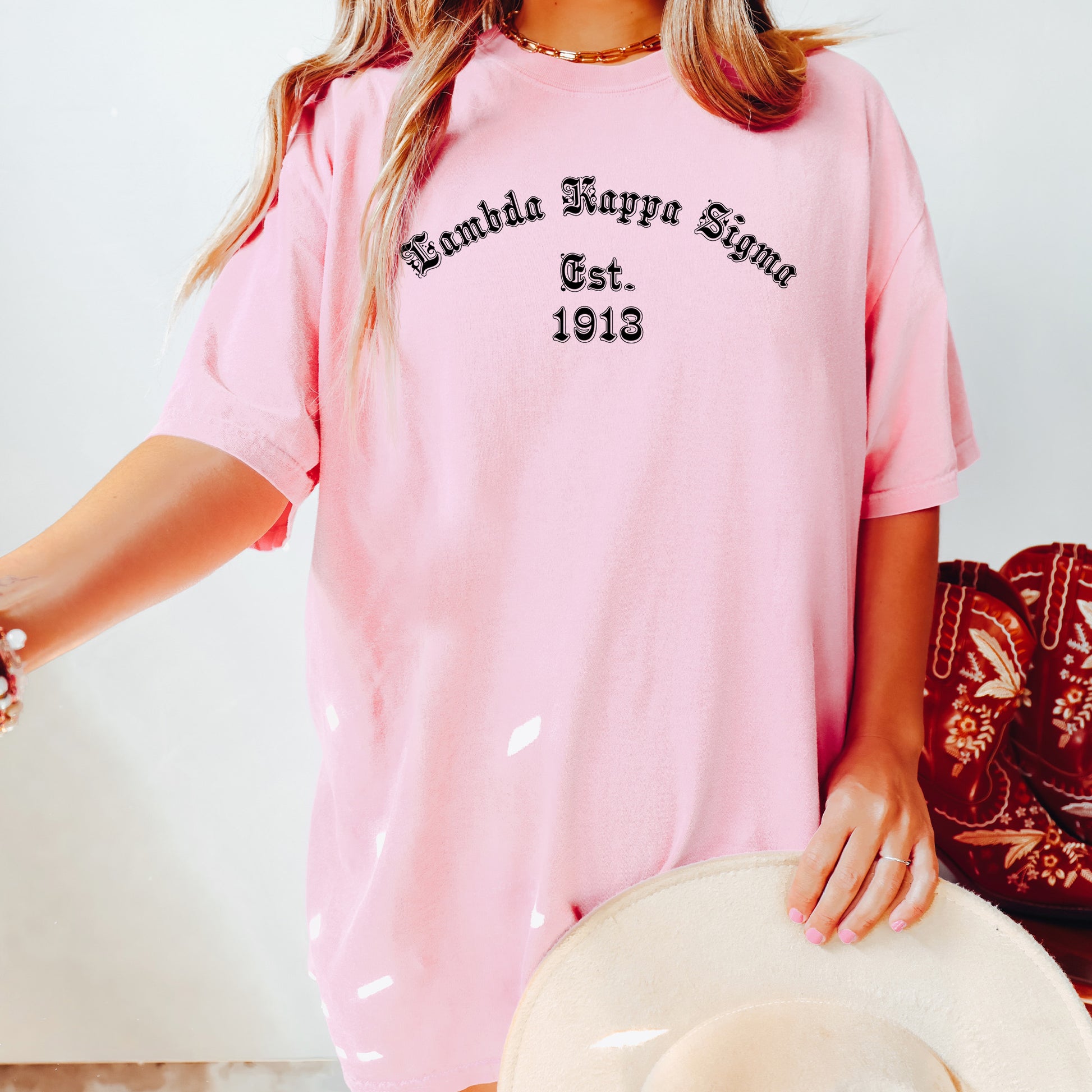 a woman wearing a pink shirt and hat
