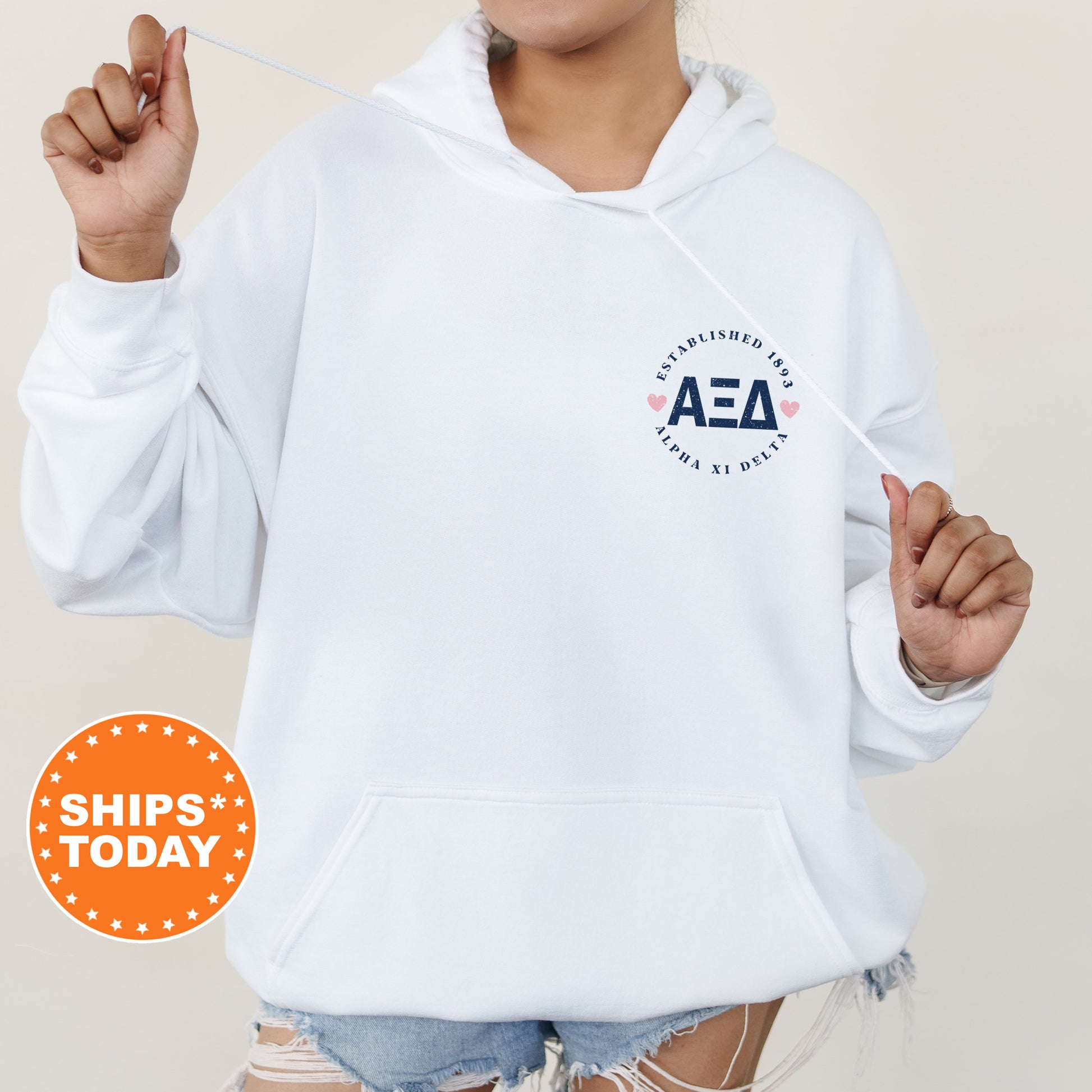 a woman in a white hoodie holding a toothbrush