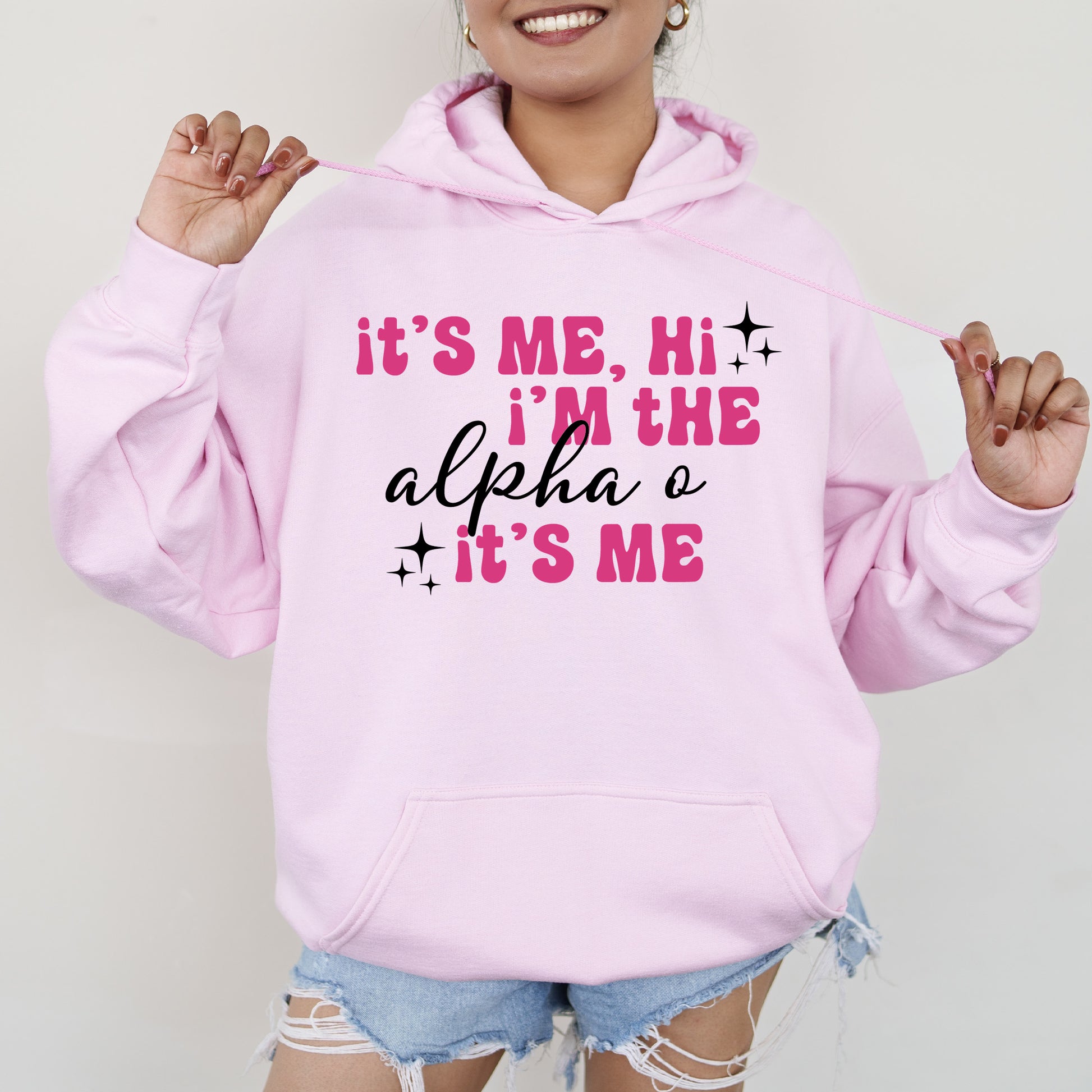 a woman wearing a pink hoodie that says it's me, he '
