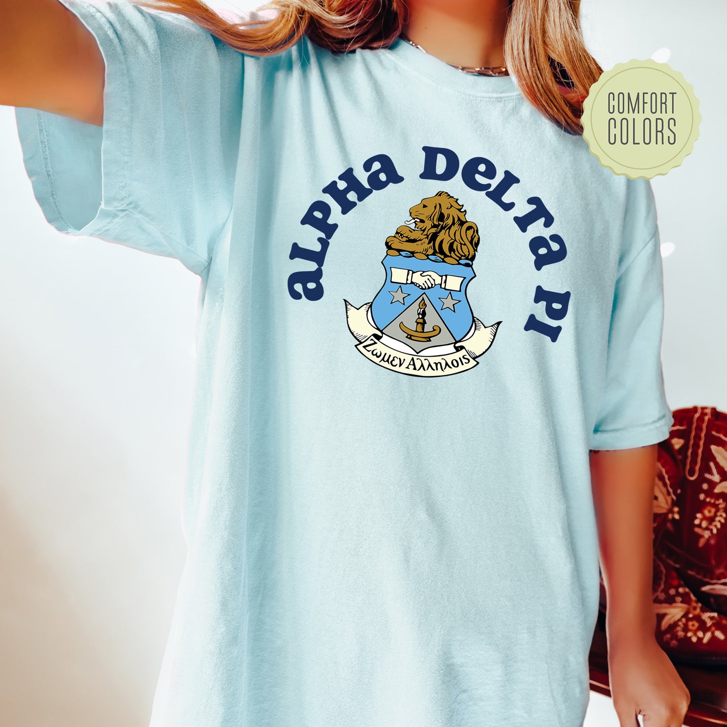a young girl wearing a blue shirt with a crest on it