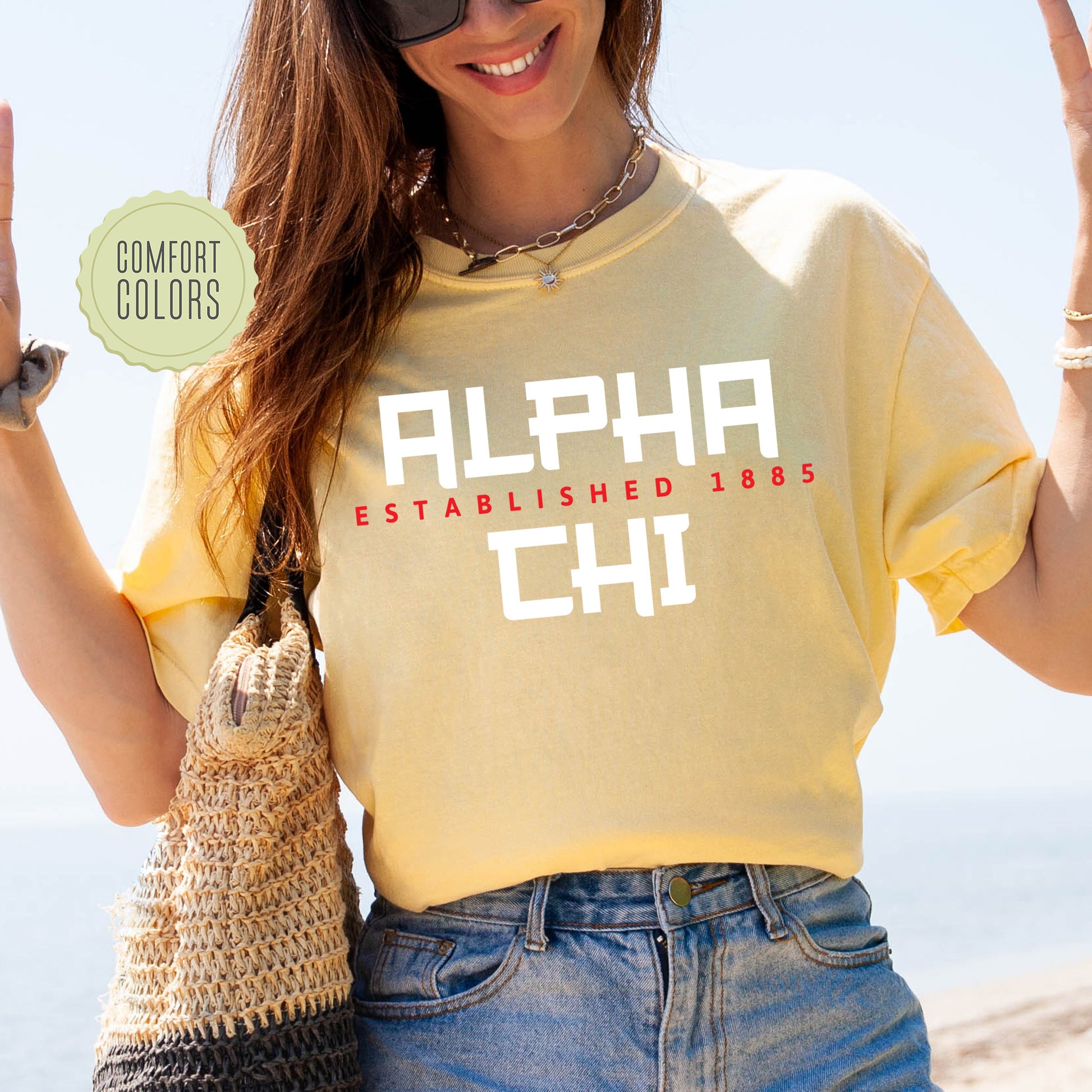 a woman in a yellow shirt holding up a peace sign