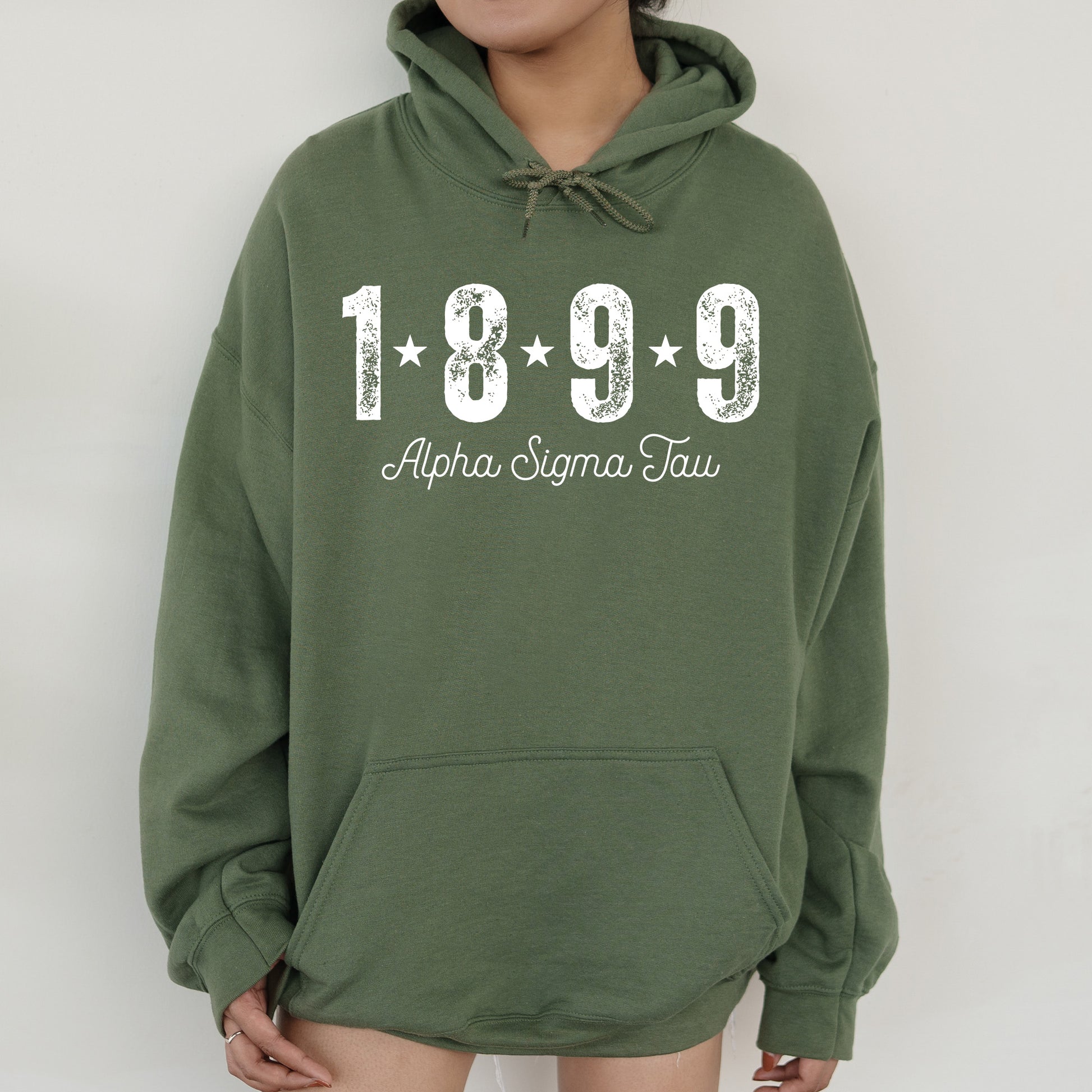 a woman wearing a green hoodie with the year 1989 printed on it