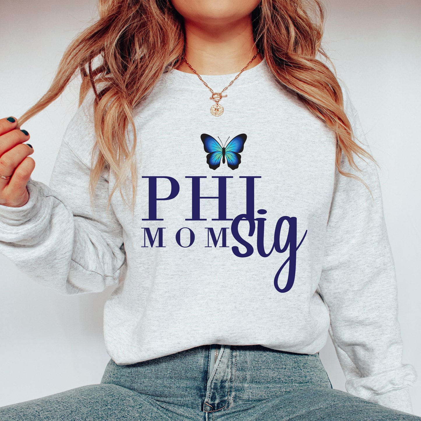 a woman wearing a sweatshirt with a butterfly on it