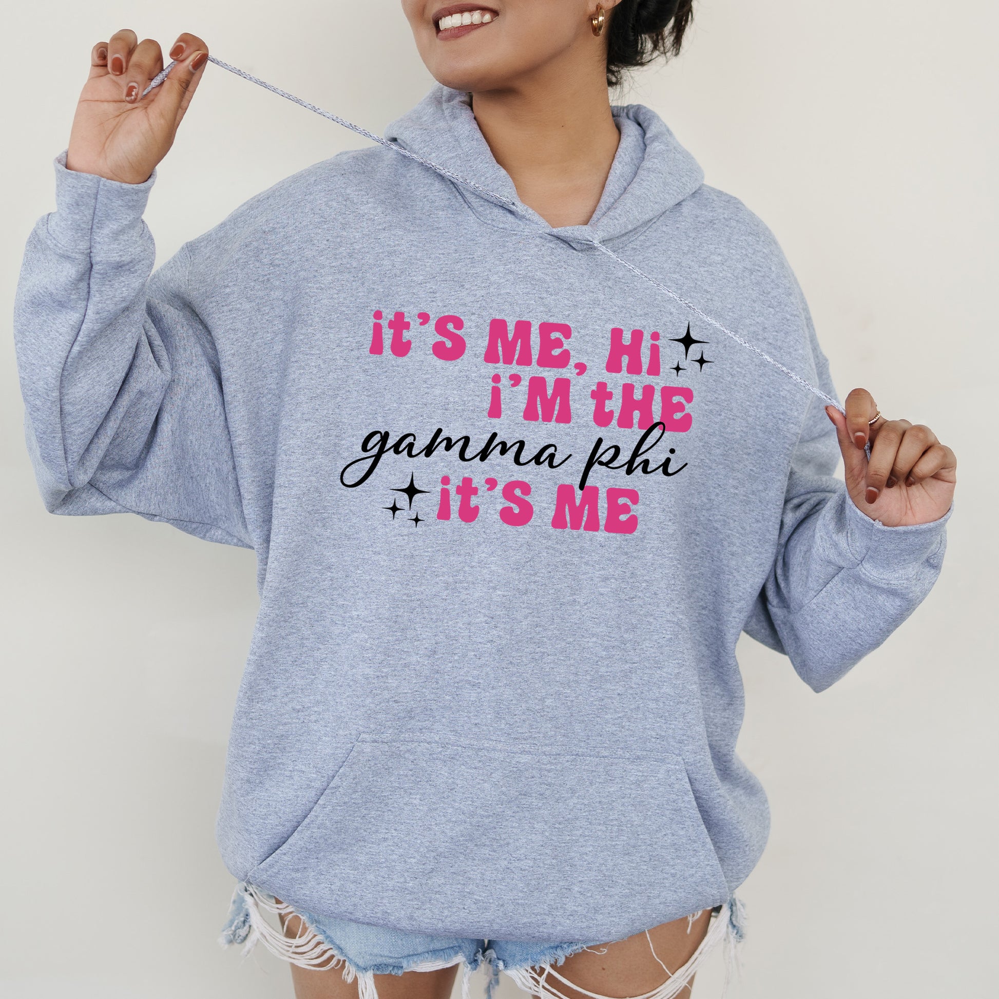 a woman wearing a gray hoodie that says it's me, i '