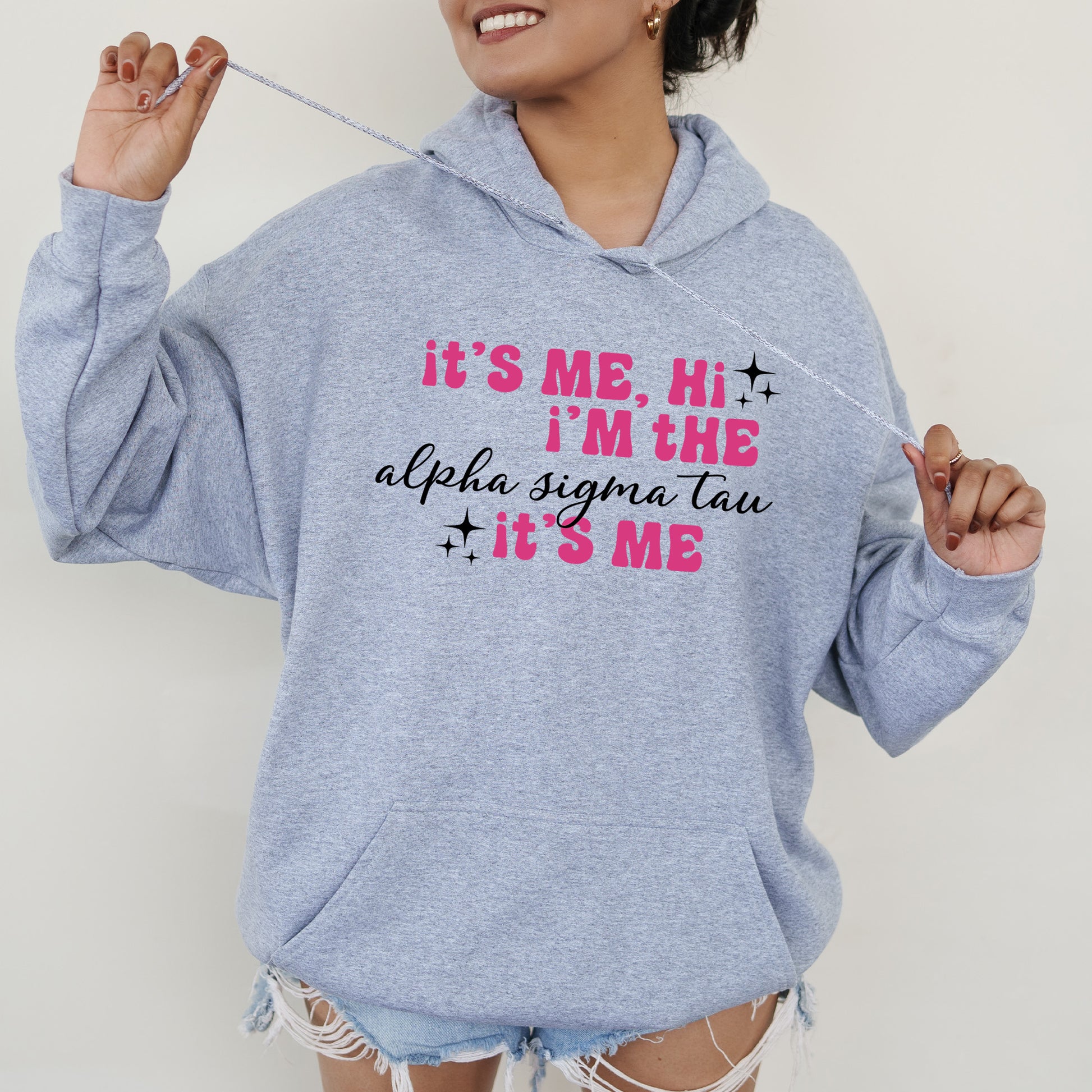 a woman in a blue hoodie is holding a toothbrush